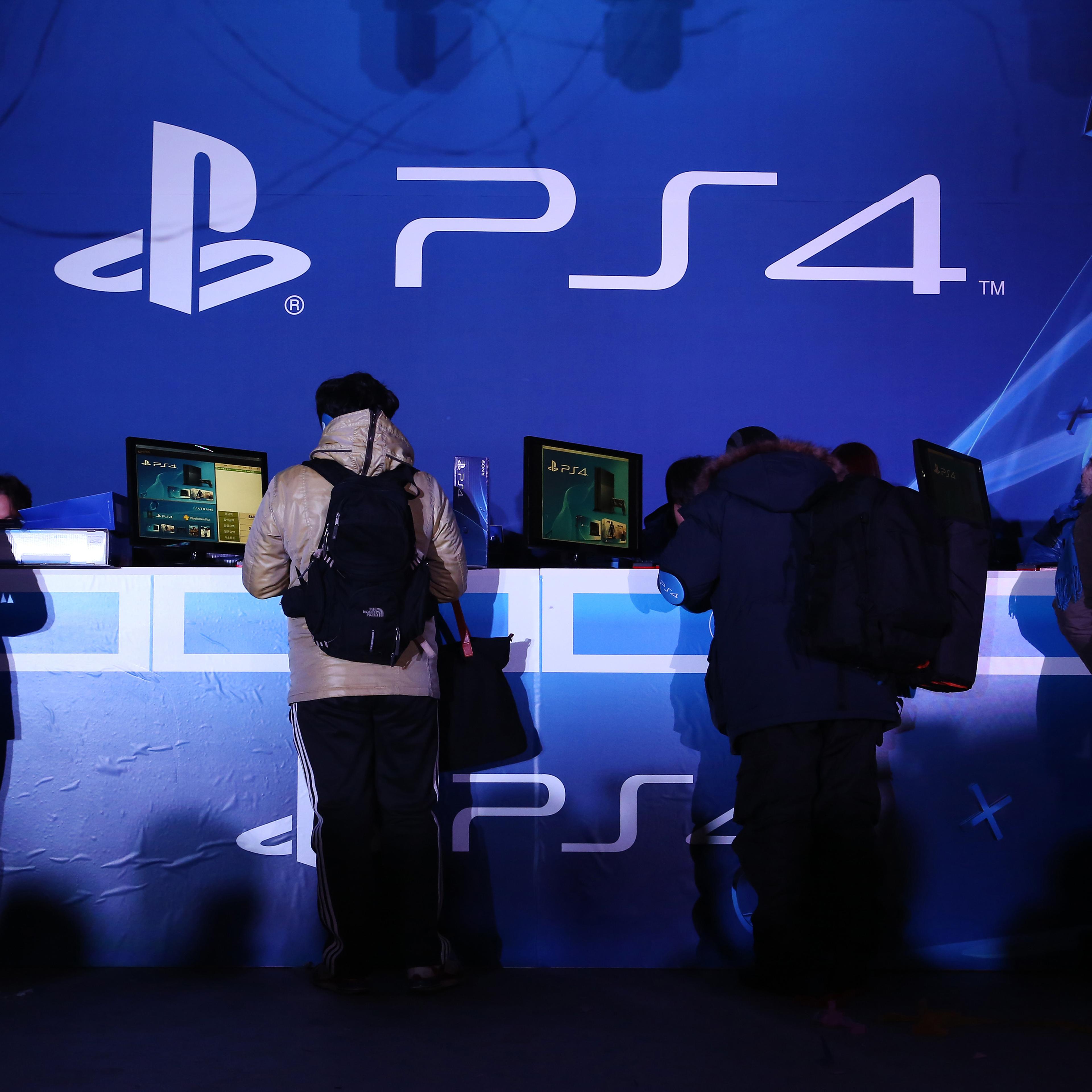 Customers buy Sony Computer Entertainment Inc.'s PlayStation 4 video game console box during the launch event in Seoul, South Korea, Dec. 17, 2013.