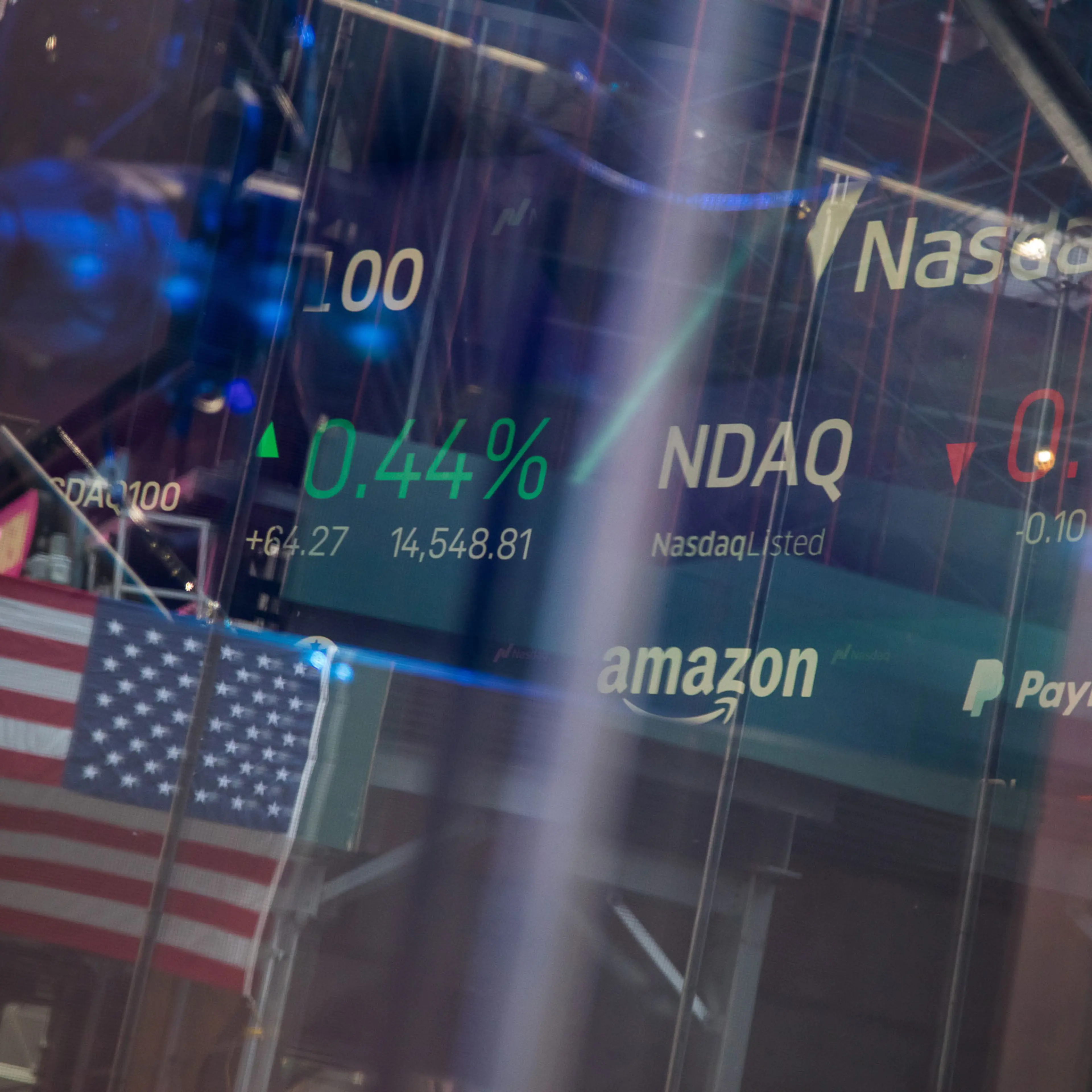 reflections in screen showing stock market information at the Nasdaq MarketSite in New York