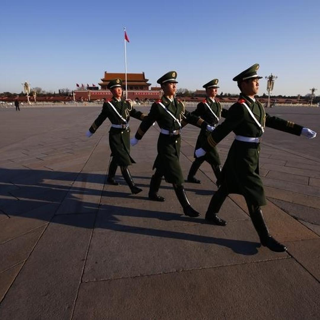 Paramilitary policemen march at the Tiananmen Square, near the Great Hall of the People, the venue holding the closing ceremony of the Chinese National People's Congress in Beijing