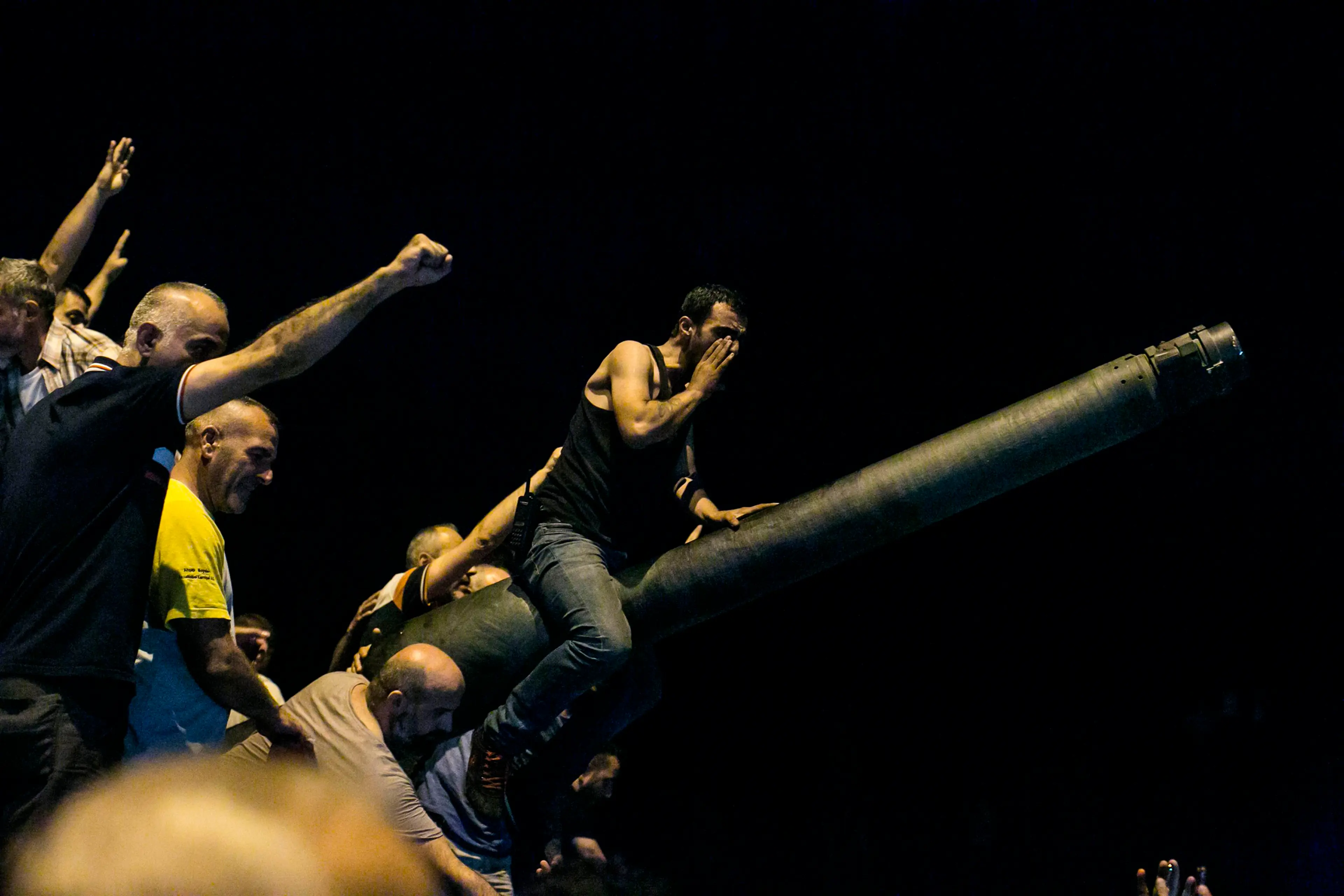 People take over a tank near the Fatih Sultan Mehmet Bridge during clashes with military forces in Istanbul, Turkey, on July 16, 2016.