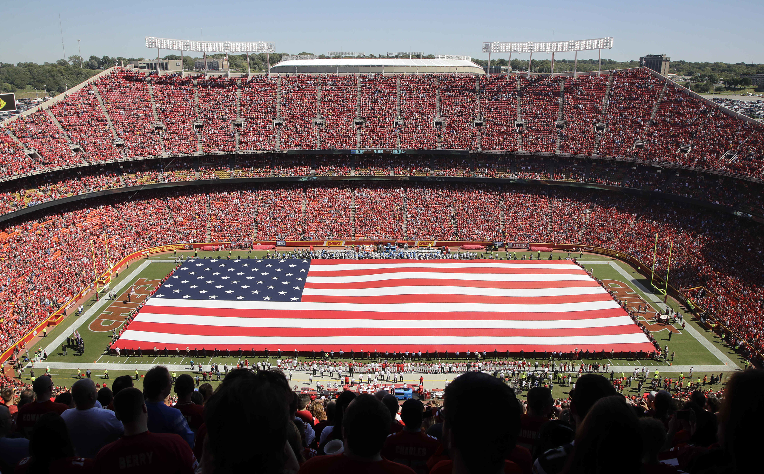 A giant flag is spread over the field at Arrowhead Stadium to commemorate Sept. 11, before an NFL football game between the Kansas City Chiefs and the San Diego Chargers in Kansas City, Missouri, Sept. 11, 2016.