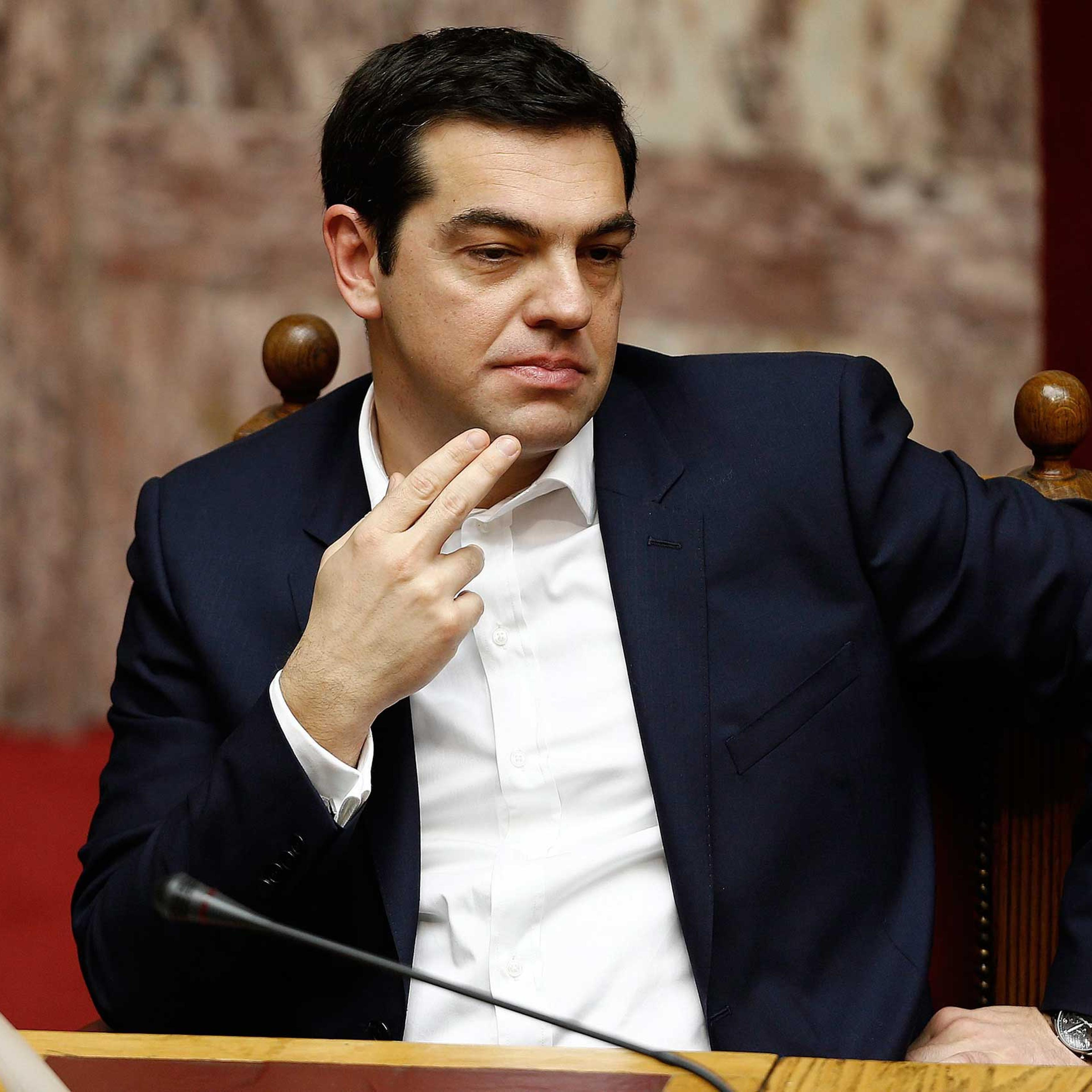 Greek Prime Minister Alexis Tsipras looks on before swearing in ceremony of the new deputies that were elected in the January 25 national polls, in Athens, Feb. 5,2015.
