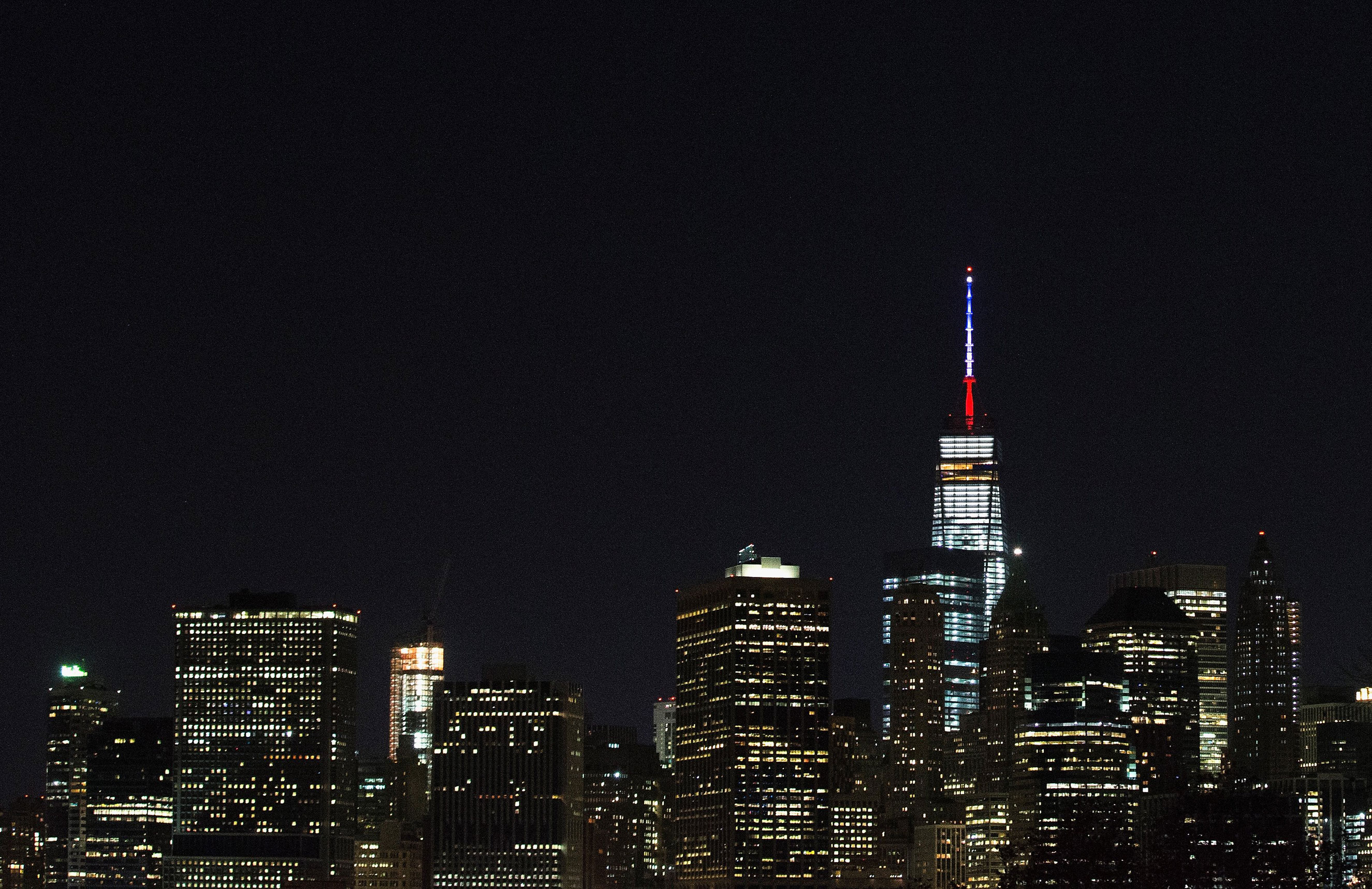 One World Trade Center's spire is lit in the colors of the French flag, white, blue and red, in solidarity with France after terror attacks in Paris on Nov. 13, 2015 in New York City.