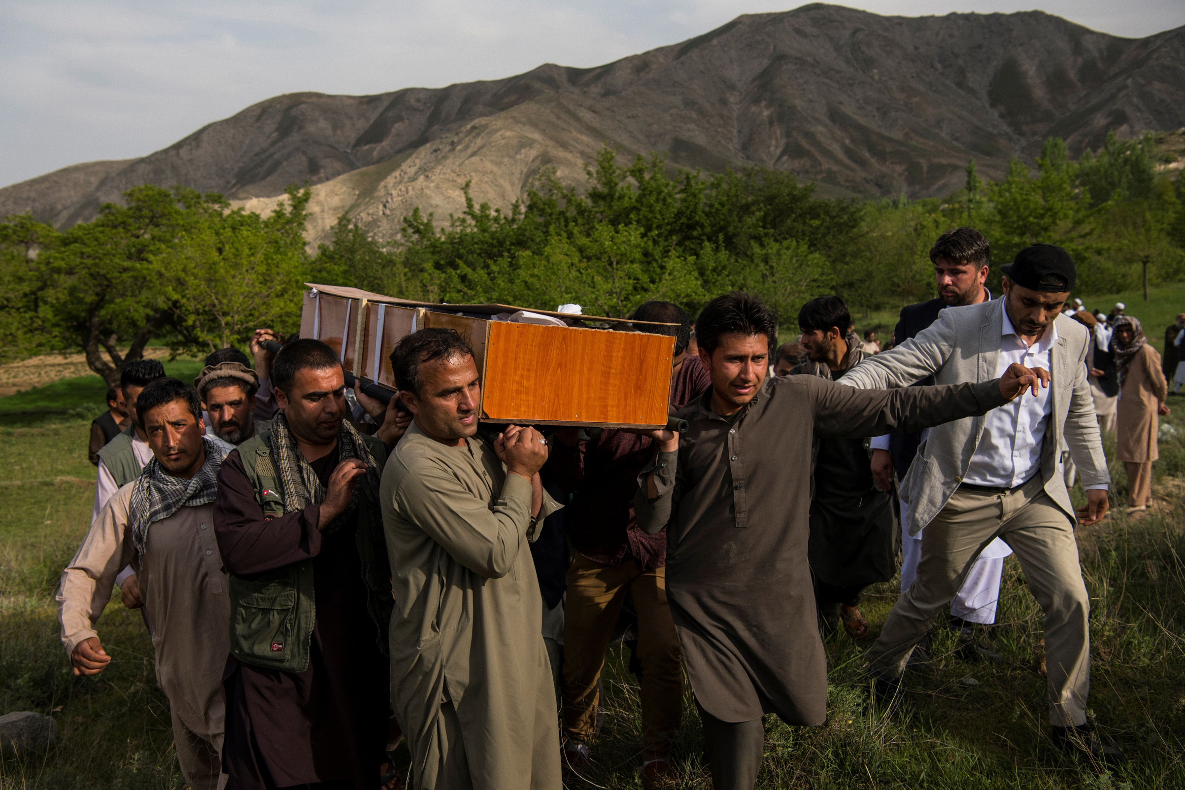 Relatives and friends of Agence France Presse Afghanistan Chief Photographer Shah Marai Faizi carry Marai's coffin before his burial in Gul Dara, Kabul, Afghanistan, on April 30, 2018.