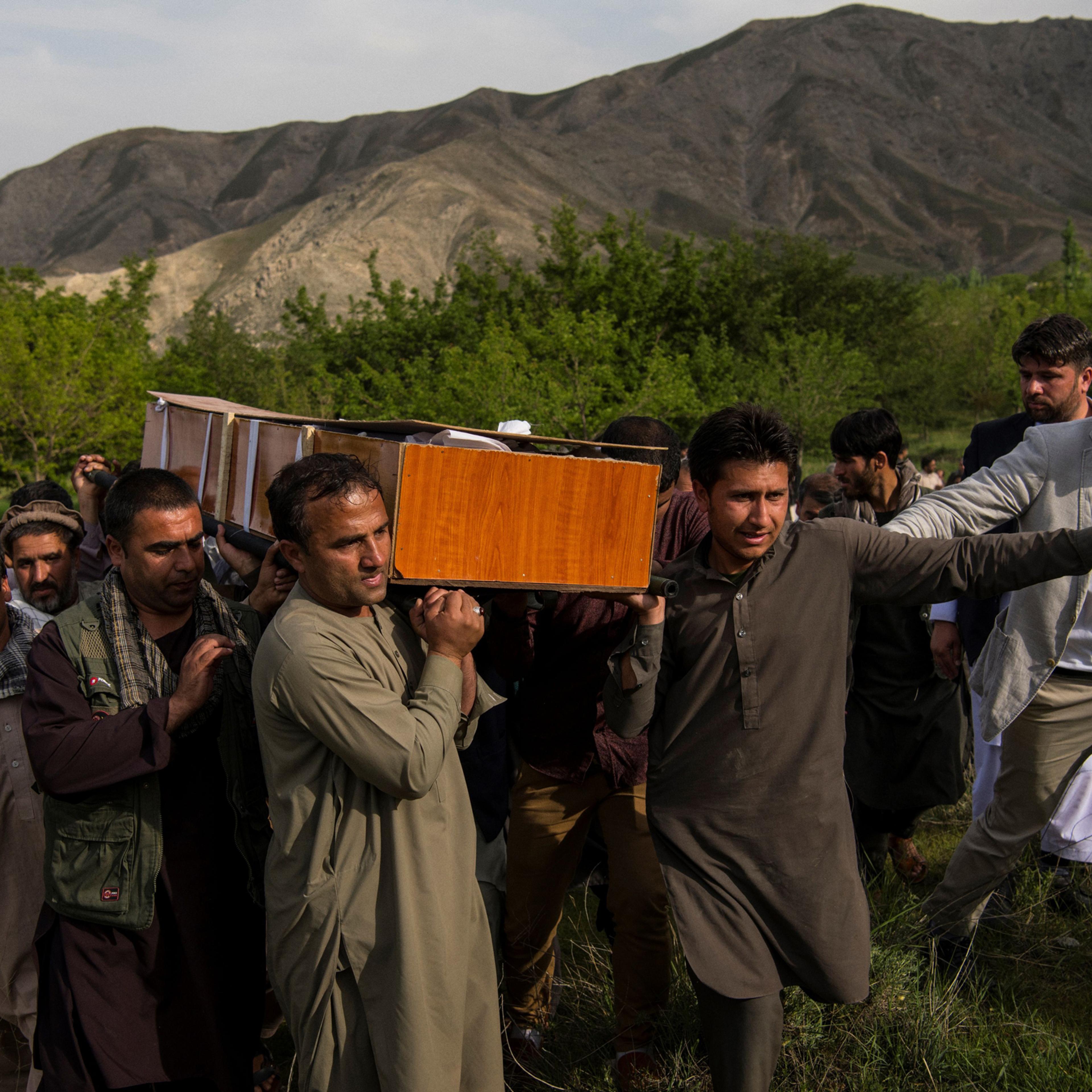 Relatives and friends of Agence France Presse Afghanistan Chief Photographer Shah Marai Faizi carry Marai's coffin before his burial in Gul Dara, Kabul, Afghanistan, on April 30, 2018.