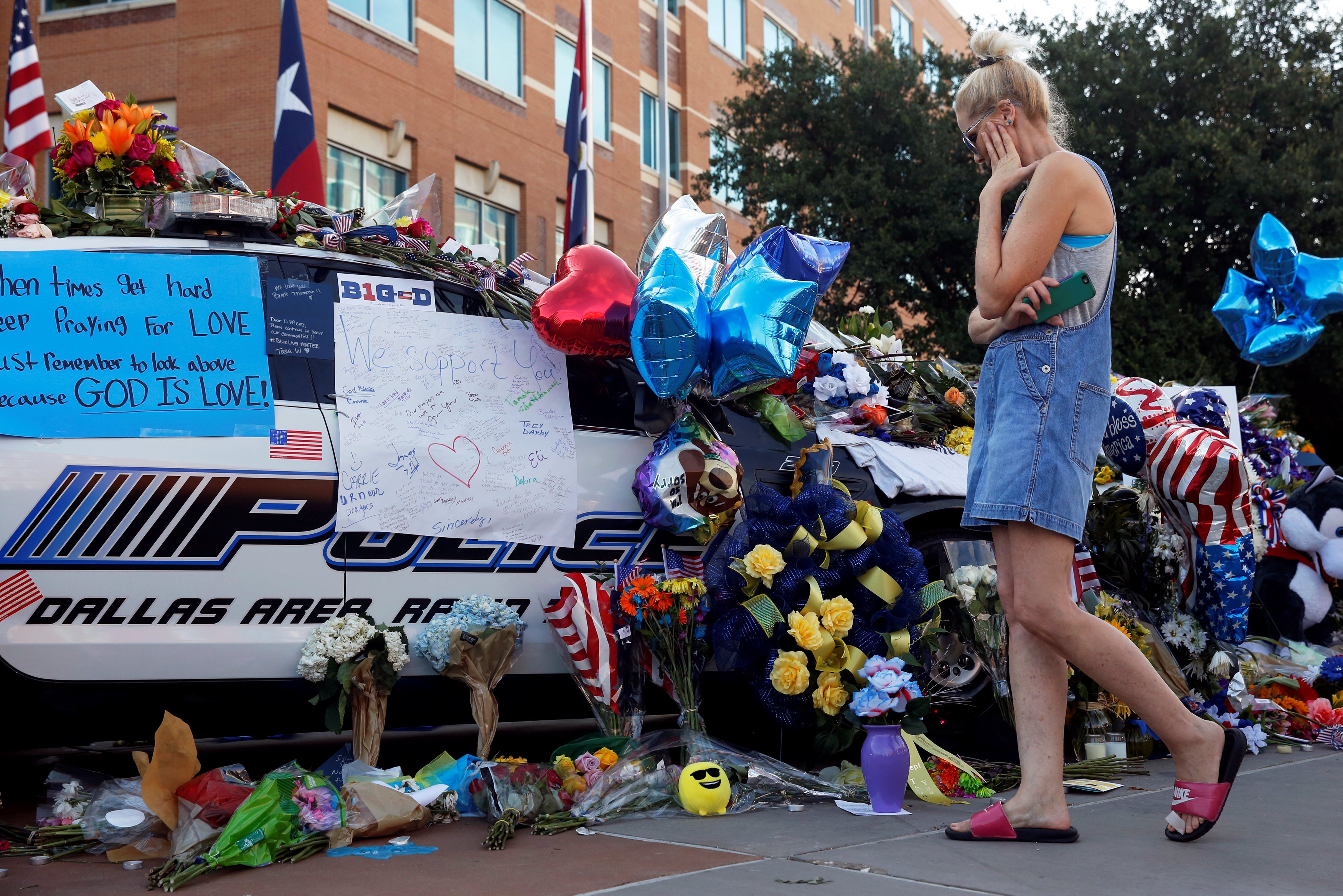 Melinda Martin visits a makeshift memorial at Dallas Police Headquarters two days after a lone gunman ambushed and killed five police officers at a protest decrying police shootings of black men, in Dallas, Texas