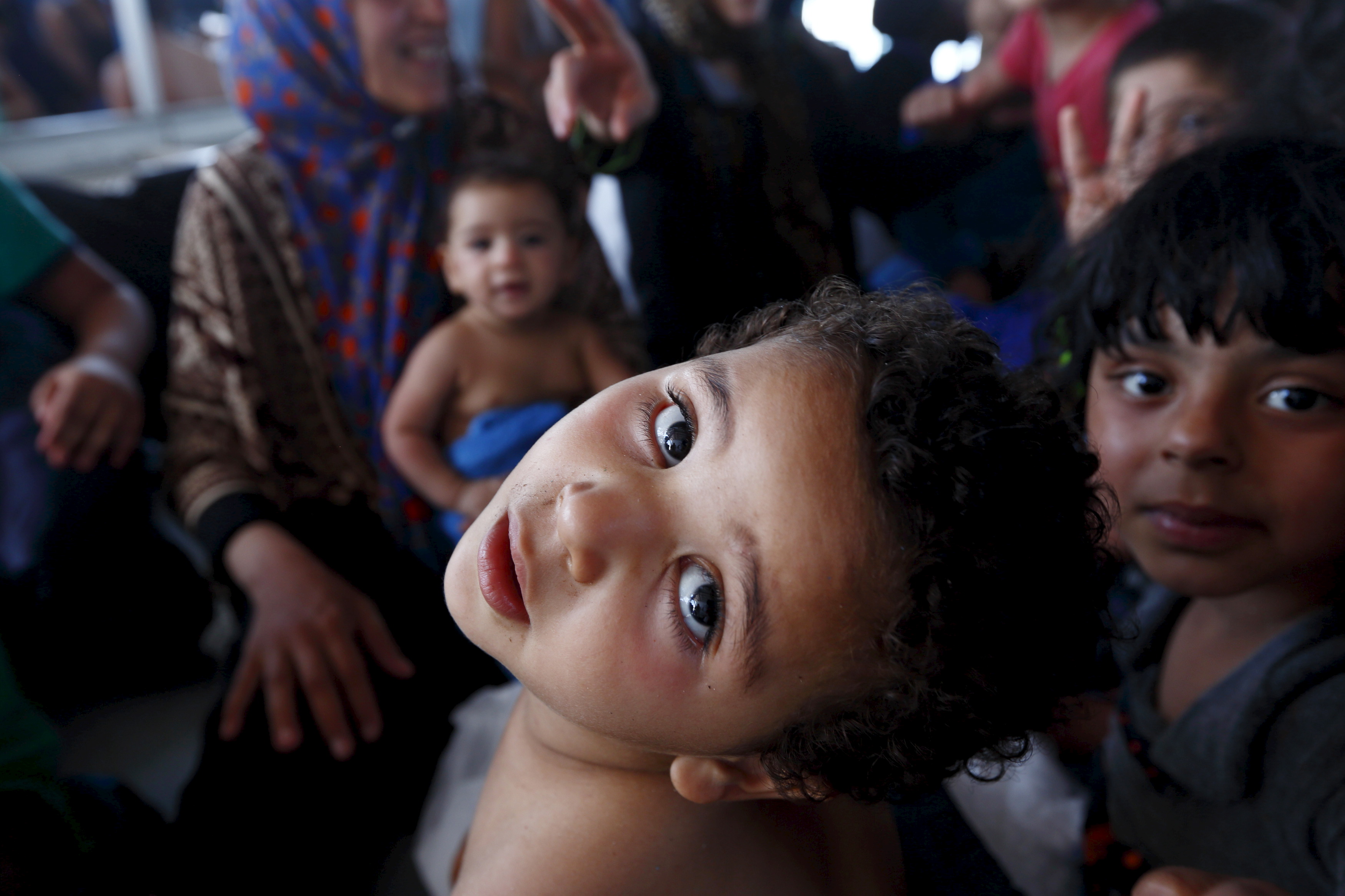 Migrant children sit on the lower deck of the MOAS ship MV Phoenix after being rescued from an overloaded wooden boat 10.5 miles off the coast of Libya
