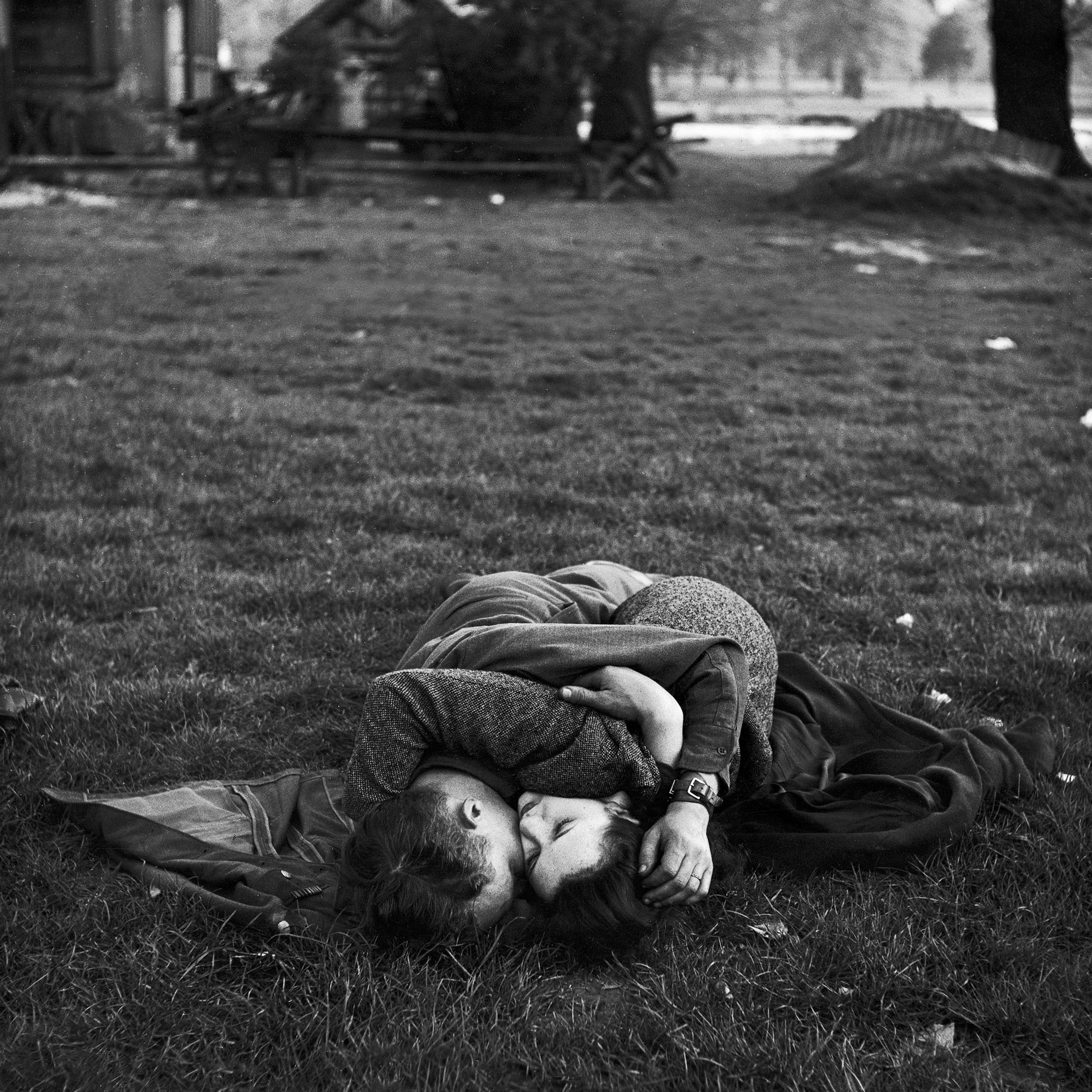 American soldier kissing his English girlfriend on lawn in Hyde Park, one of the favorite haunts of US troops stationed in England.
