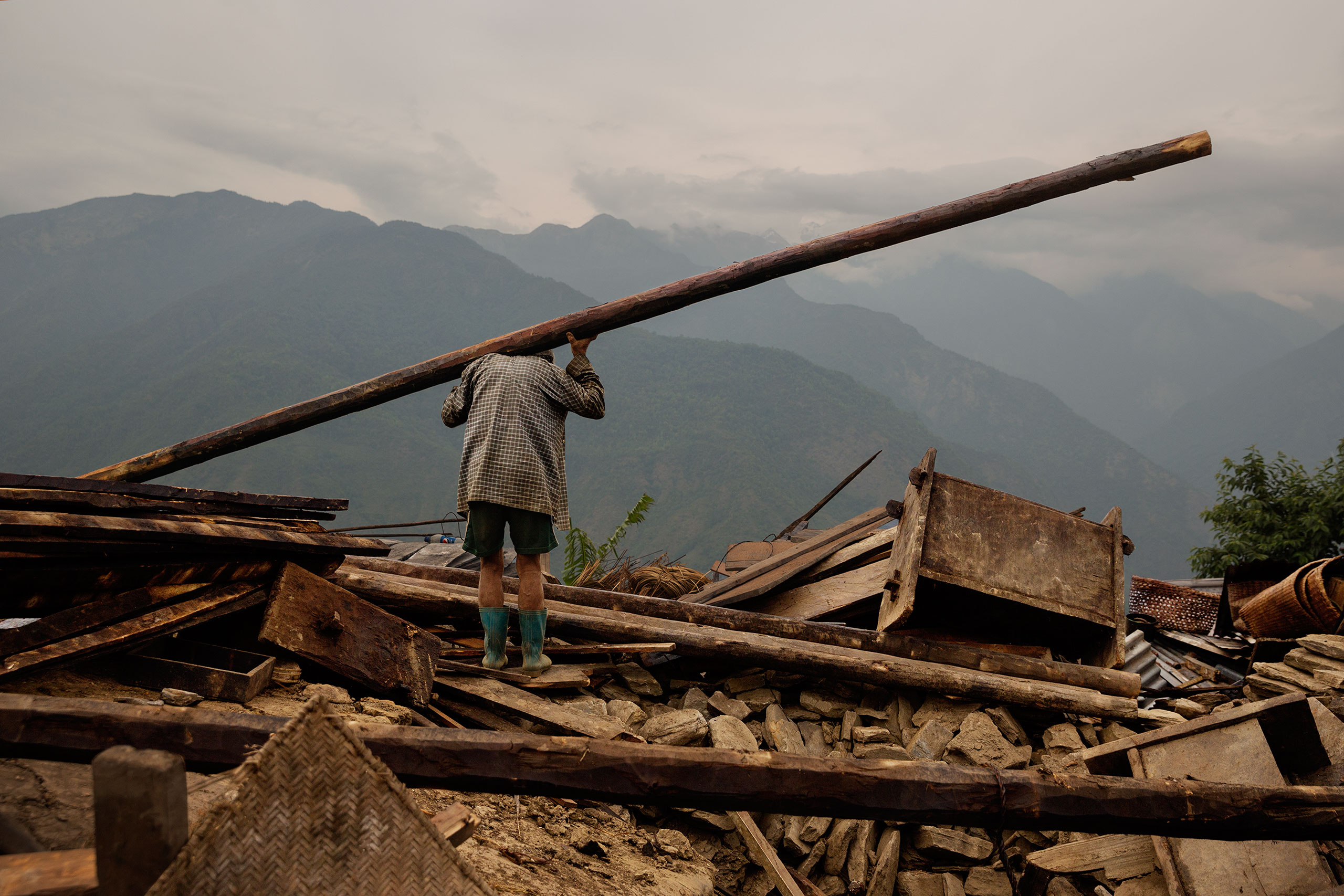 Nepal earthquake. Barpak, the epicenter of the earthquake. Funeral of Pur Bahadur Gurung, 26, who had just been dug out of the rubble. Saainli Gurung, his mother weeping. Scenes of villagers salvaging building materials and personal possessions. Dhan Raj