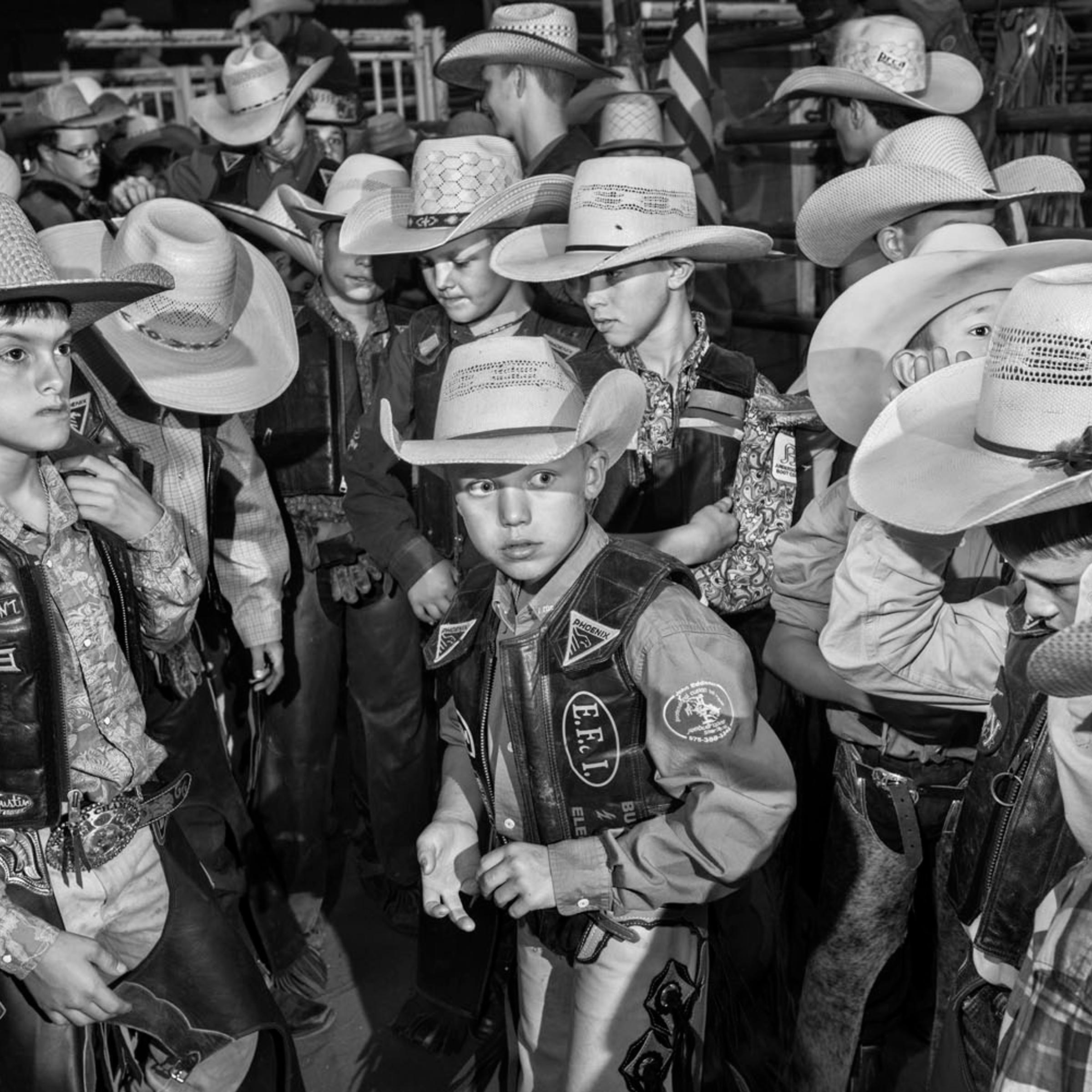 August 2, 2014: Finalist mutton busters and calf riders wait in the arena alley before the invocation and their introduction on the final day of competition.