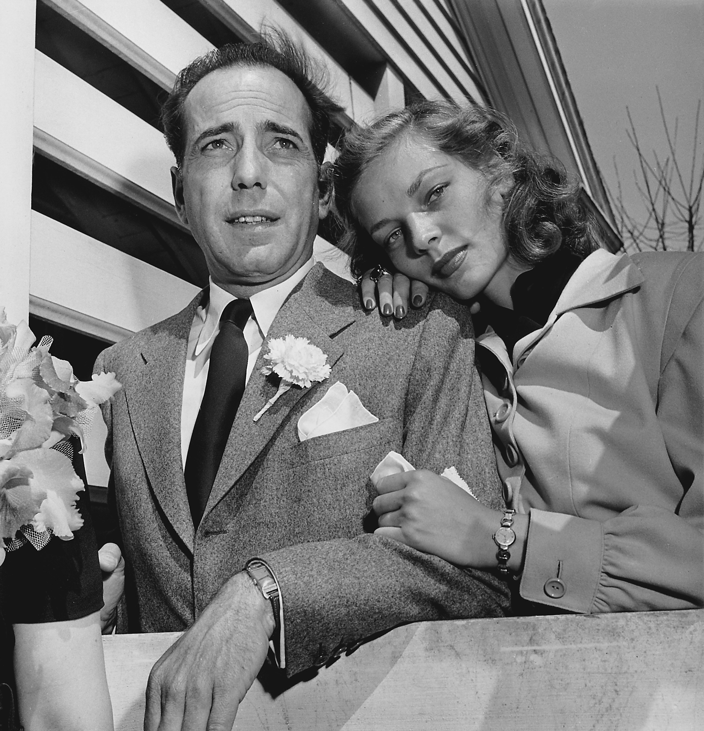 Newlywed actors Humphrey Bogart and Lauren Bacall attending wedding reception at the home of novelist Louis Bromfeld.