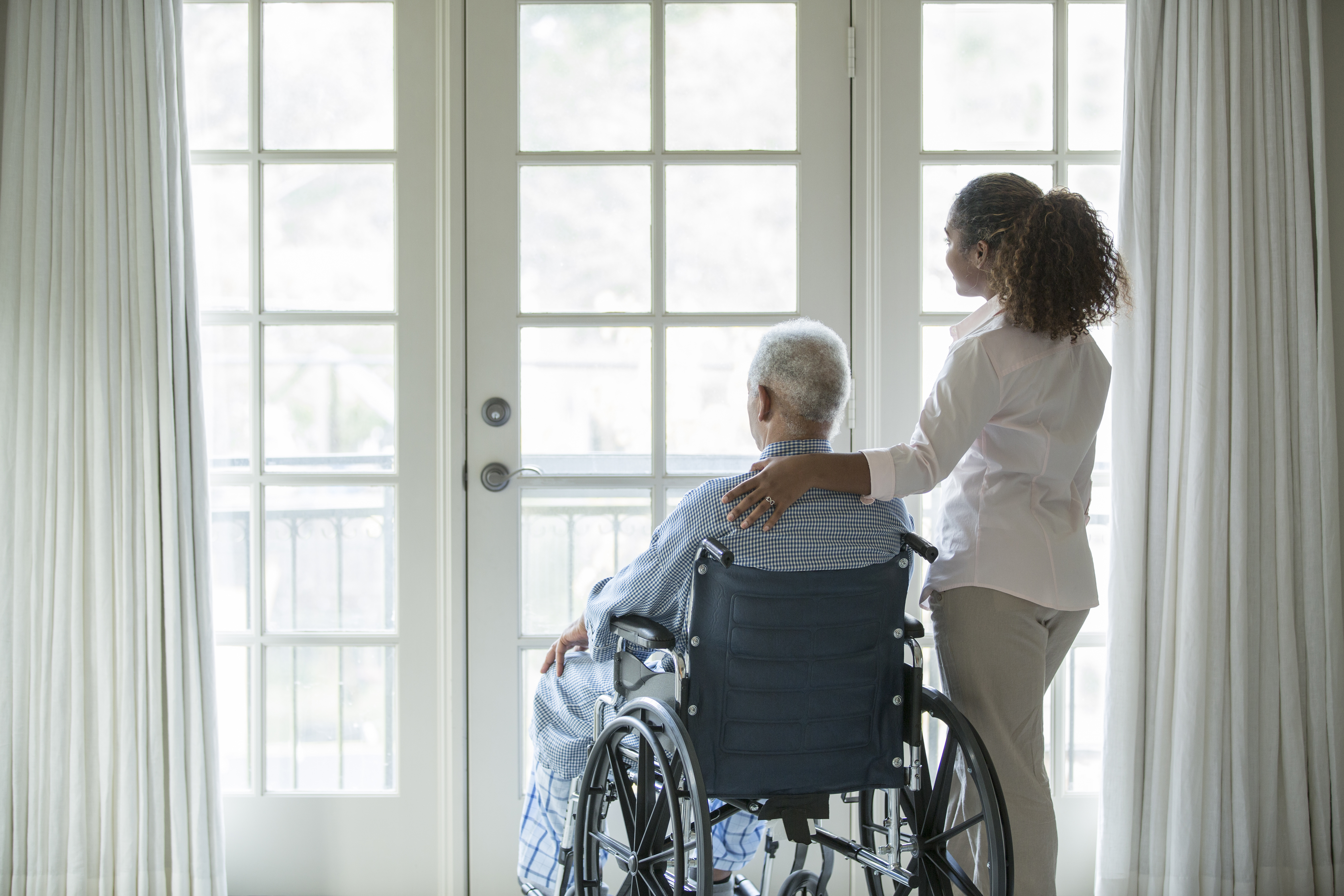 African American woman with Senior man in wheelchair