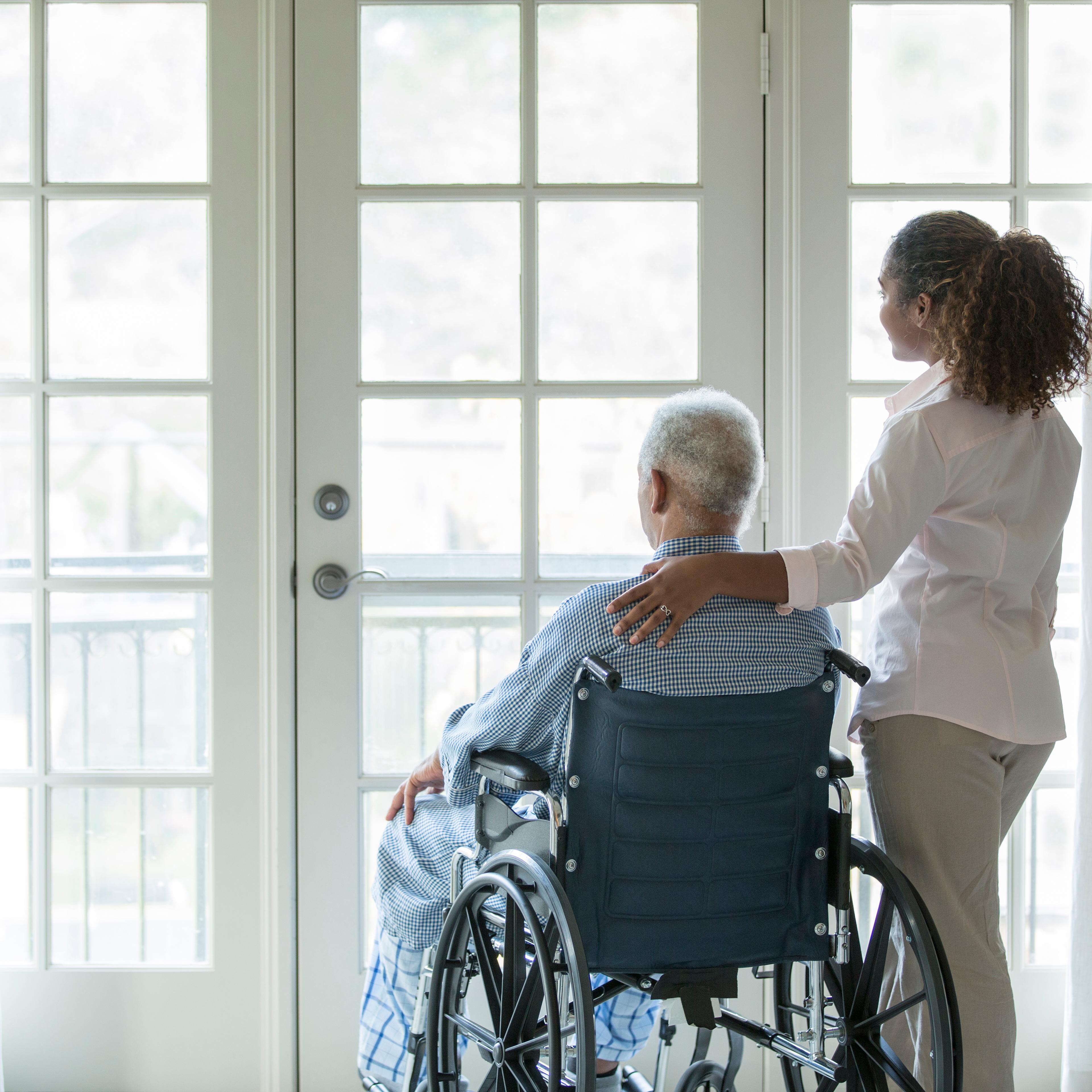 African American woman with Senior man in wheelchair