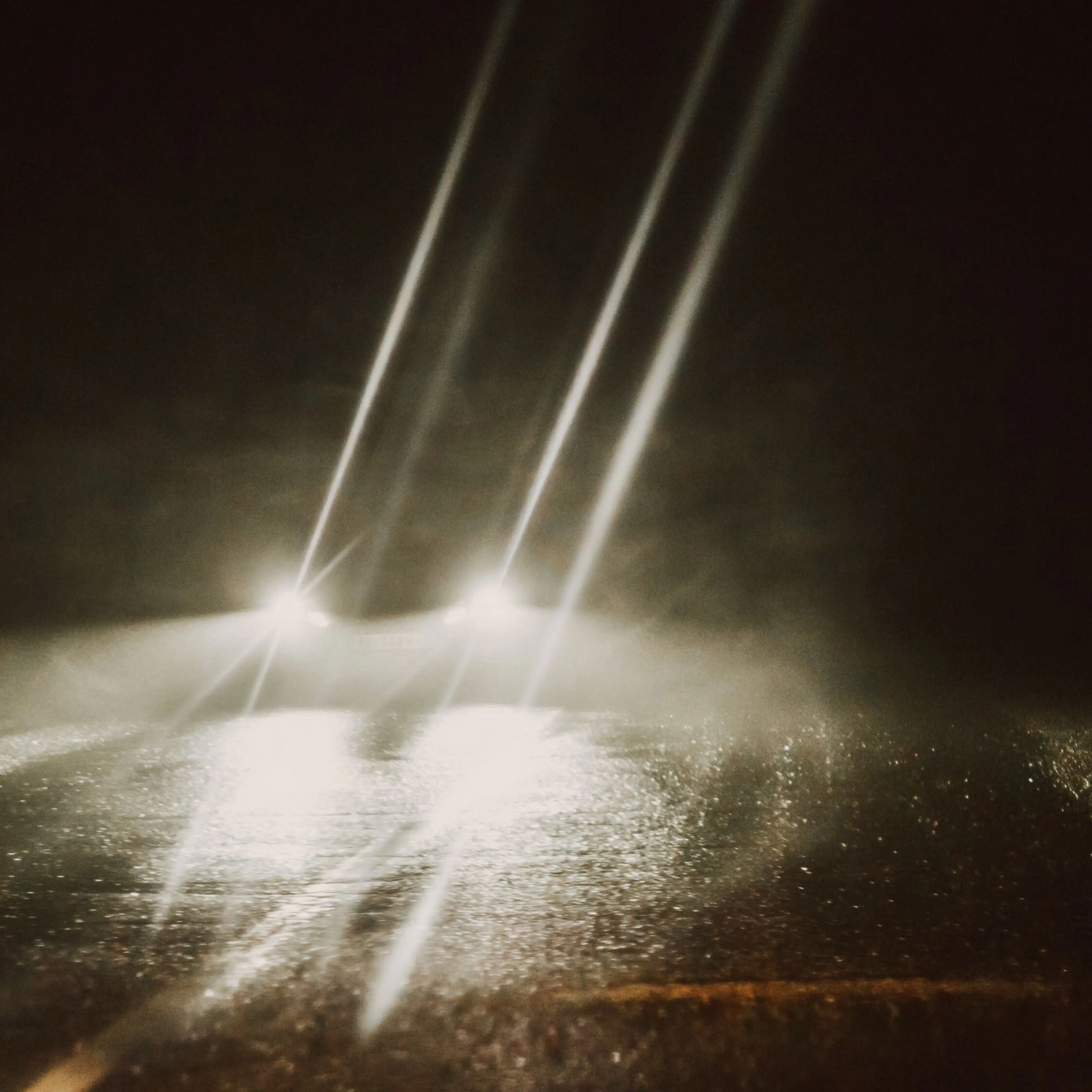 A car at night with headlights on.