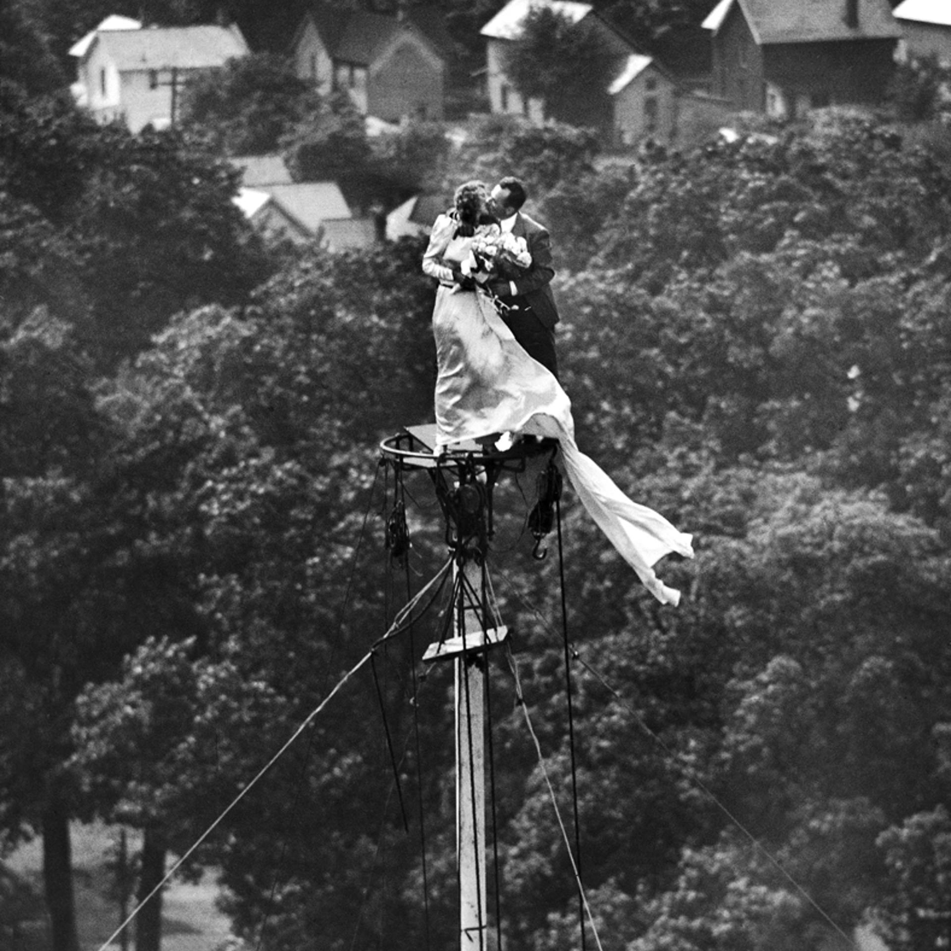 Engaged couple Marshall and Yolanda Jacobs kiss atop a flagpole, Coshocton, Ohio, June 1946, prior to their wedding.