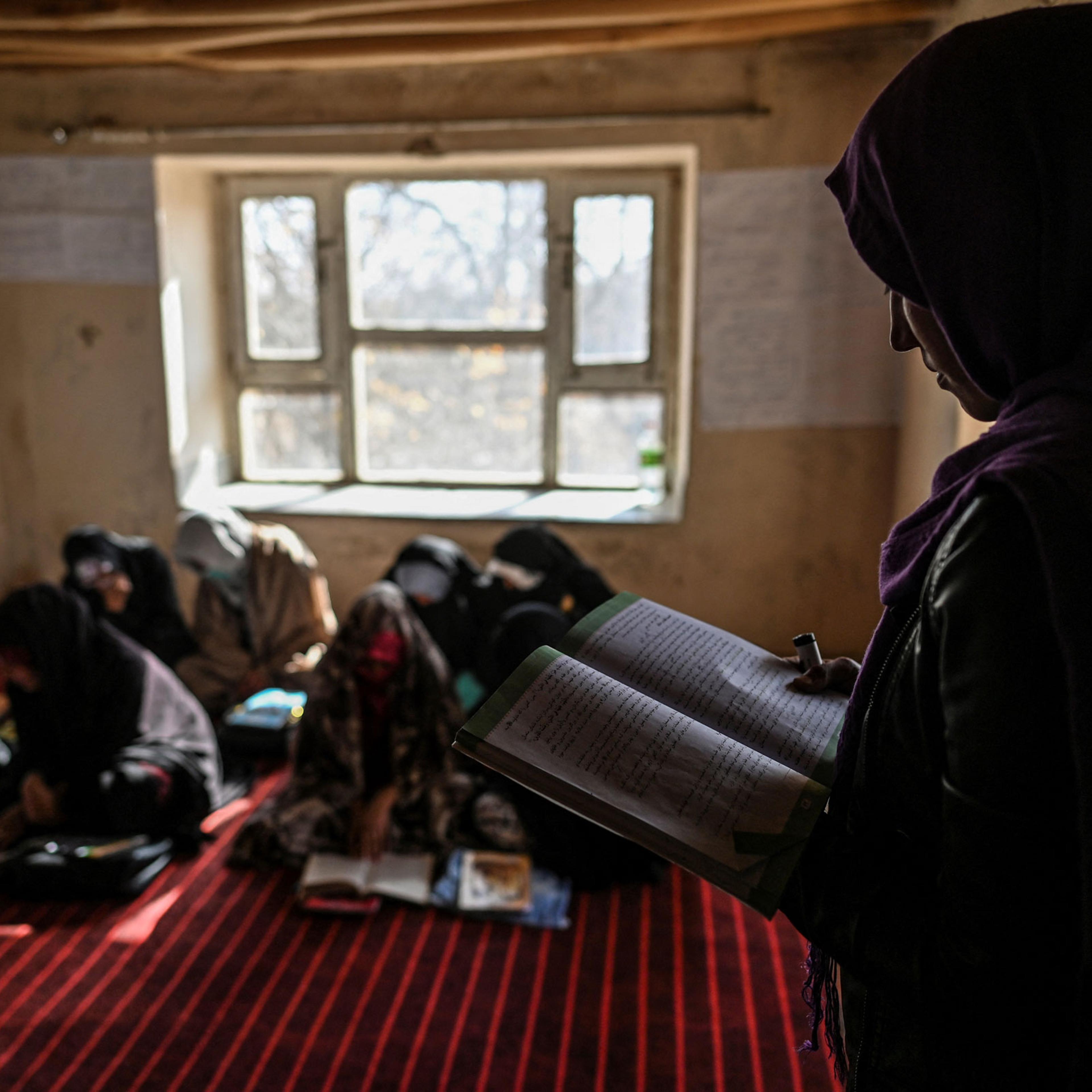 a teacher reading inside a class of grade 12 at a school in Langar village
