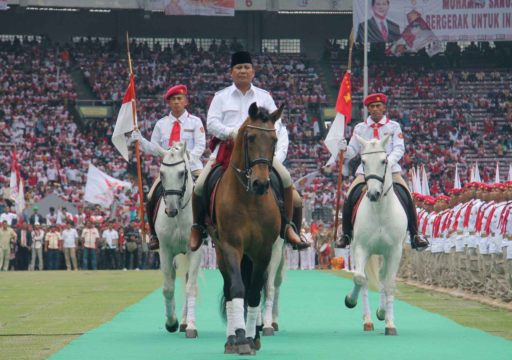 Retired general Prabowo Subianto rides a horse at a stadium in Jakarta during a campaign rally of the Gerindra party on March 23, 2014
