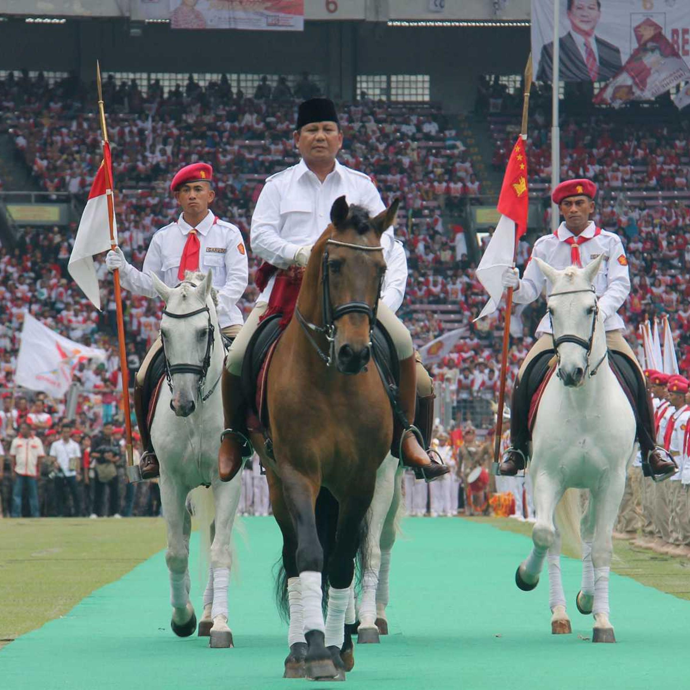 Retired general Prabowo Subianto rides a horse at a stadium in Jakarta during a campaign rally of the Gerindra party on March 23, 2014