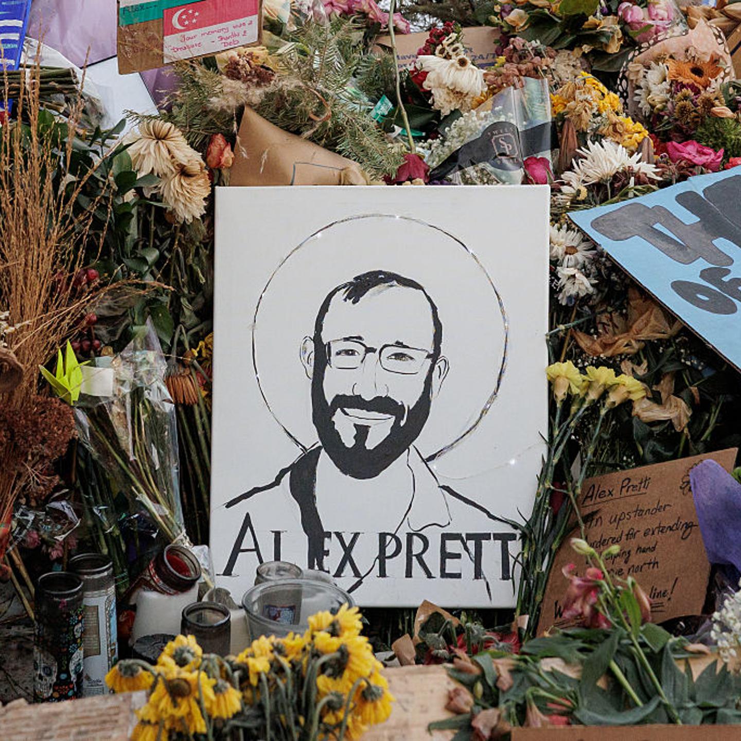 Signs and flowers left by mourners are seen at the makeshift memorial for Alex Pretti in Minneapolis, Minn., US, on Jan. 29, 2026.