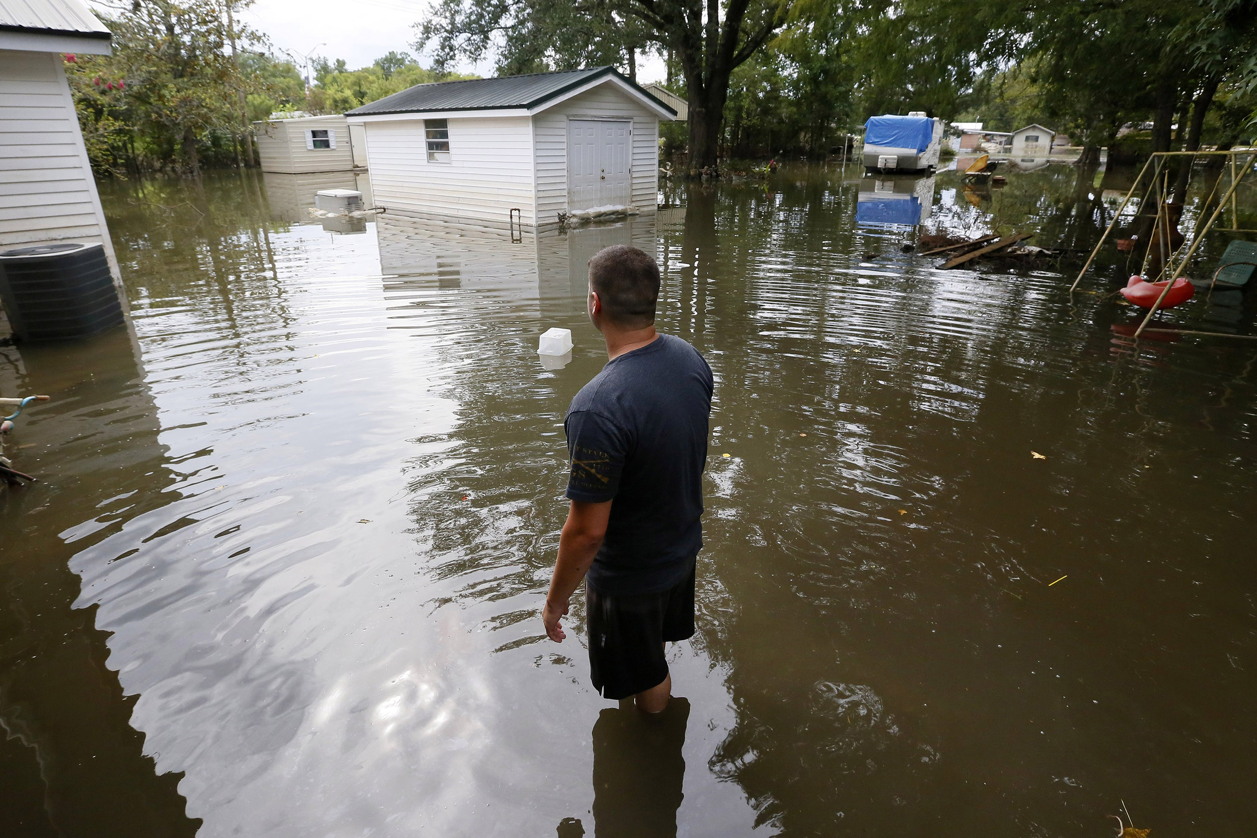 Chris Landaiche looks out to his flooded backyard in Sorrento, Louisiana, Aug. 21, 2016.