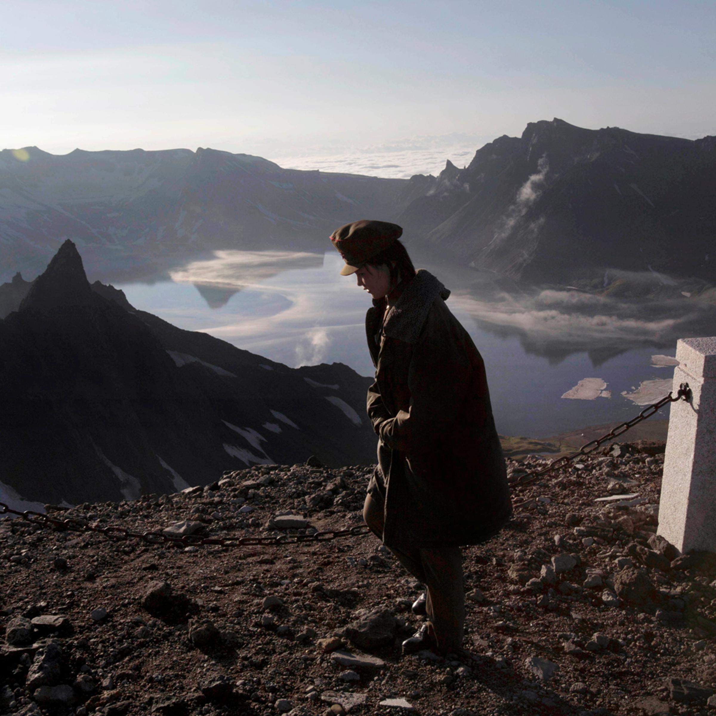 A North Korean woman walks on the peak of Mt. Paektu in North Korea's Ryanggang province, June 18, 2014 .