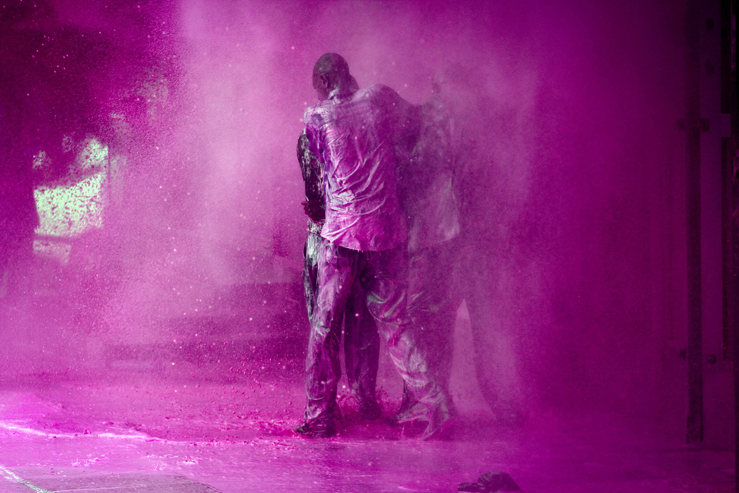 Ugandan opposition politician Olara Otunnu is shielded by his supporters during an attack with water cannon by Ugandan police after he refused to stop his protest march through central Kampala, May 10, 2011.