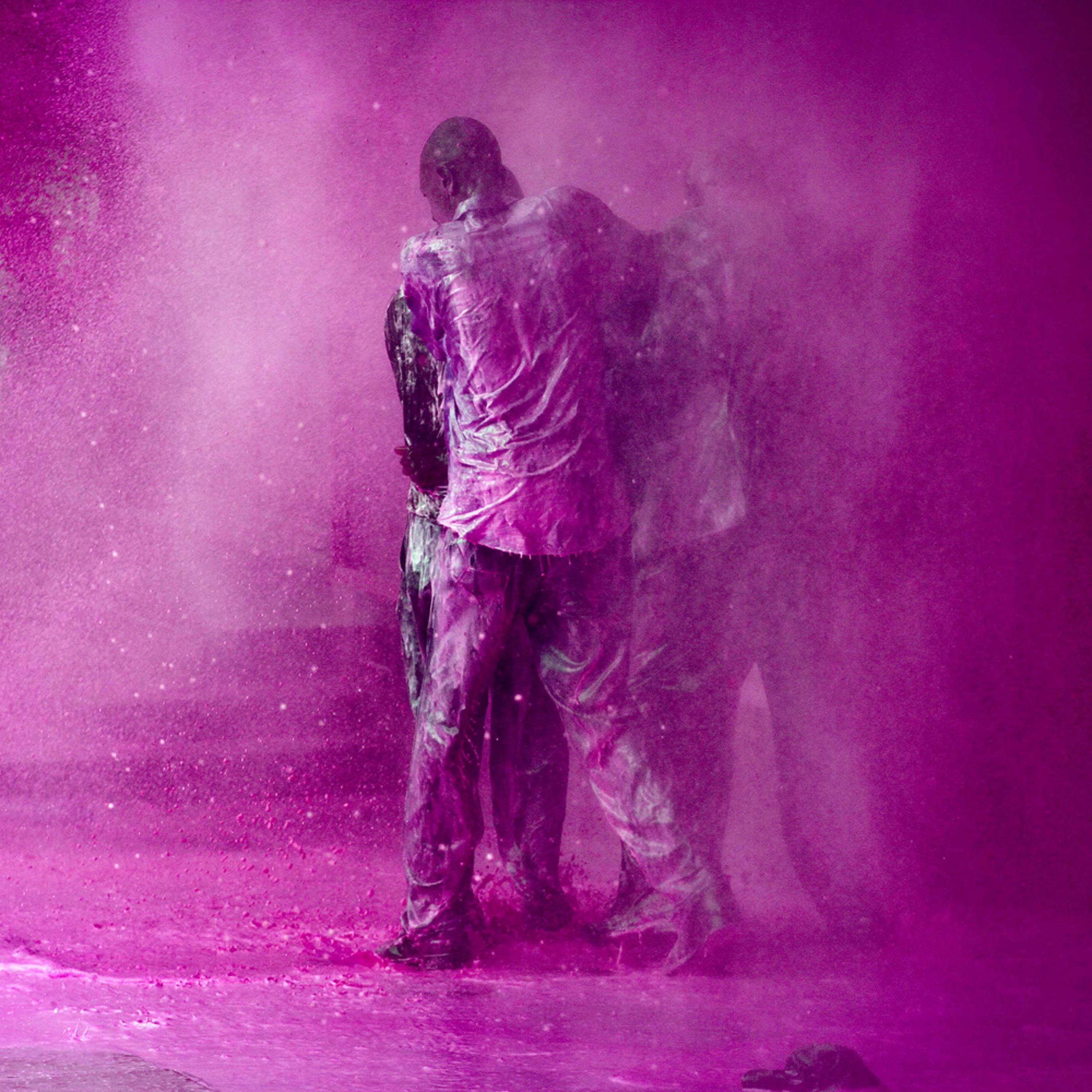 Ugandan opposition politician Olara Otunnu is shielded by his supporters during an attack with water cannon by Ugandan police after he refused to stop his protest march through central Kampala, May 10, 2011.