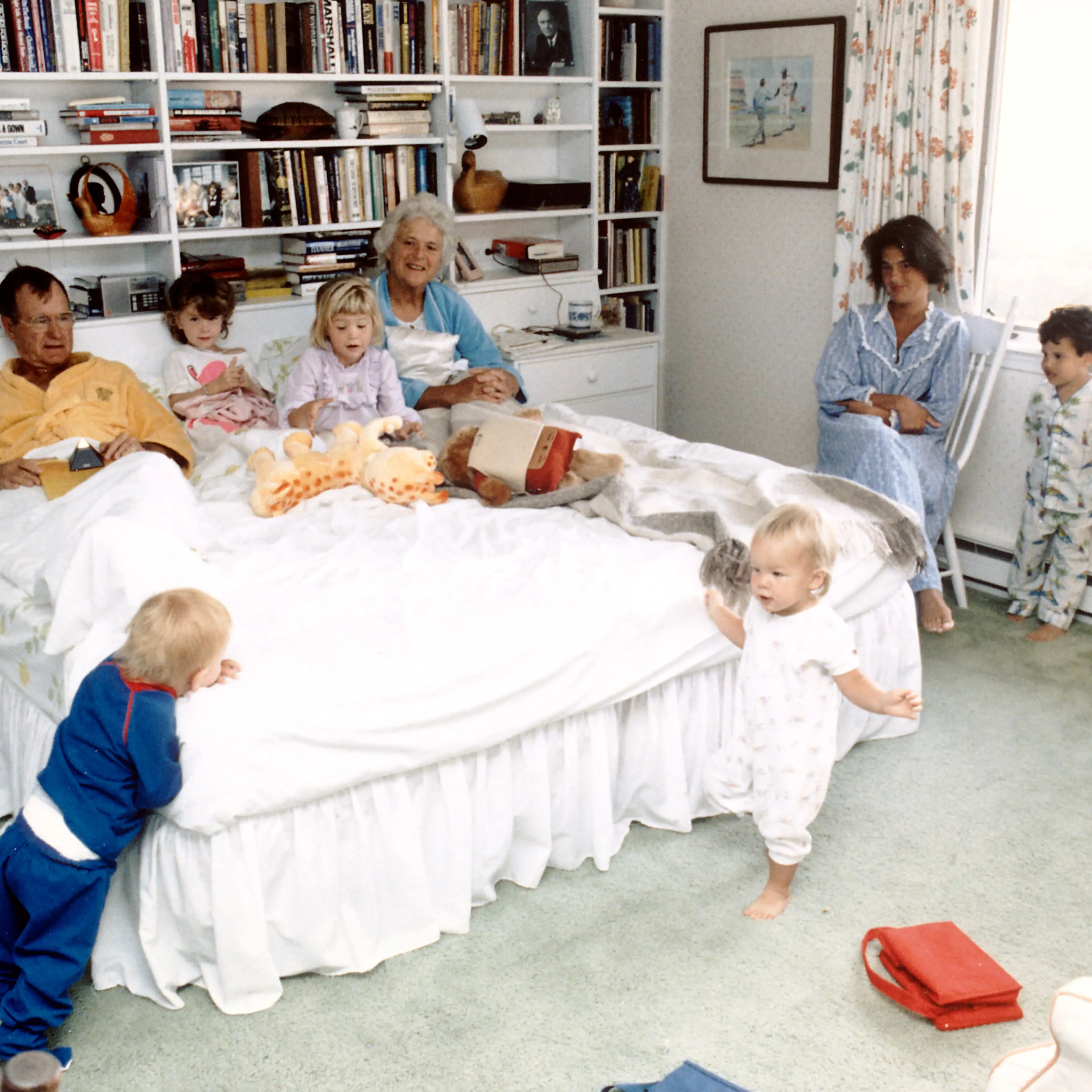 President George H.W. and Barbara Bush in bedroom get-together with their grandchildren (L-R) Pierce, twins Barbara and Jenna (in bed), Marshall, Jeb. Jr. and Sam LeBlond. 1987.
