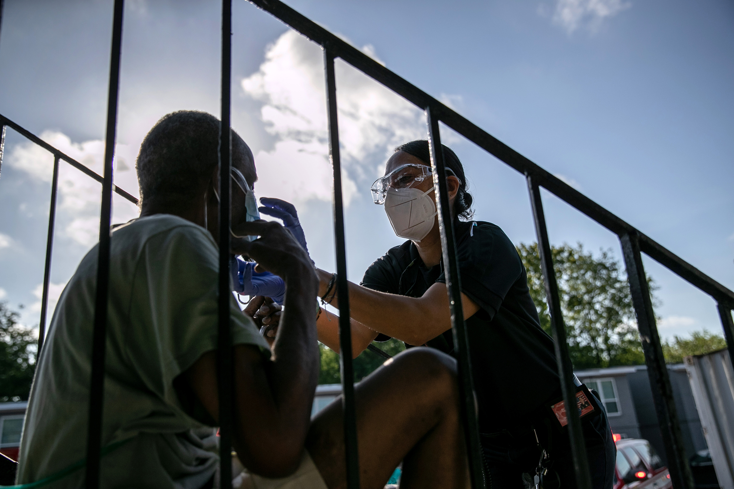 A medic from Houston’s fire department gives a patient oxygen before taking him to the hospital on Aug. 14