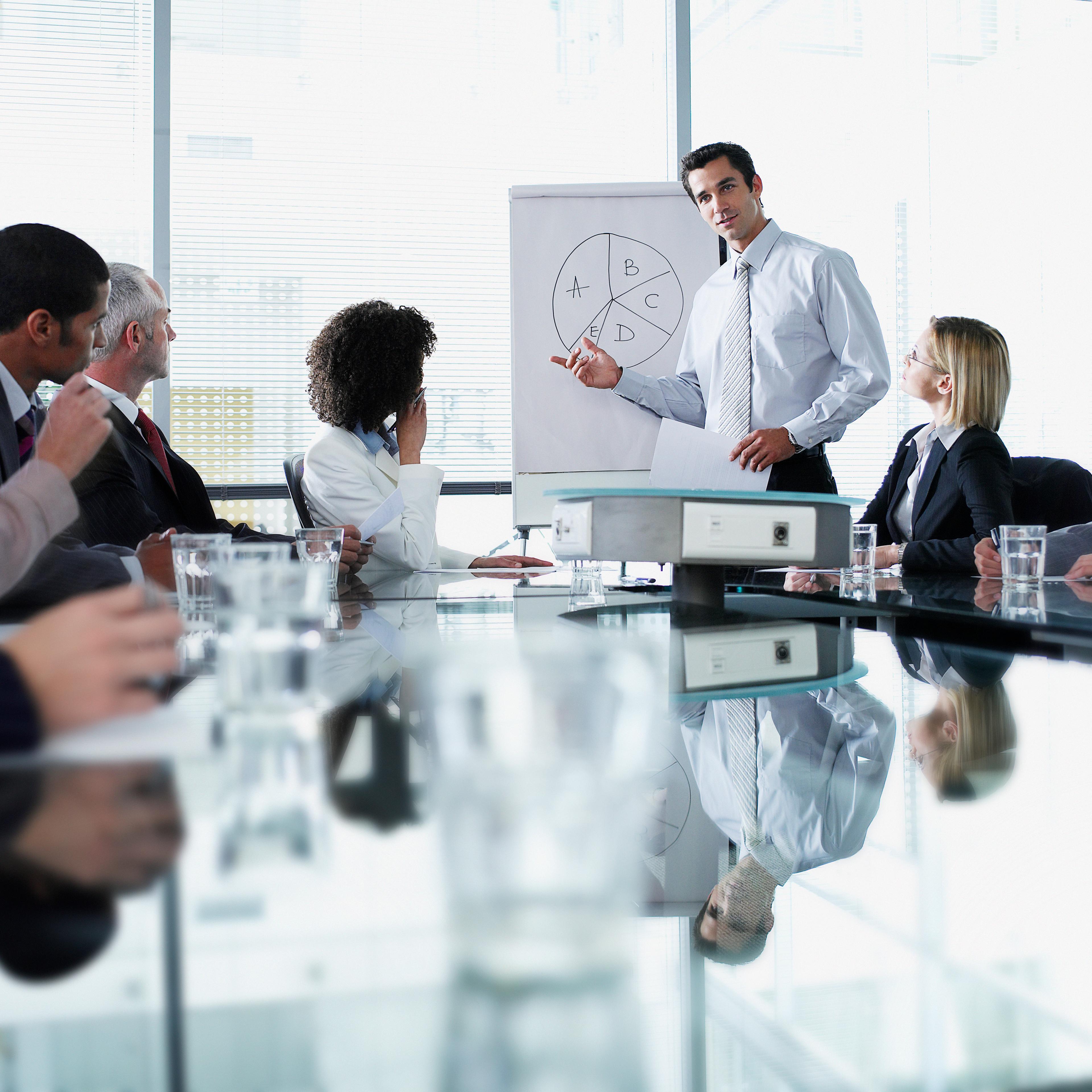 Group of office workers in a boardroom presentation