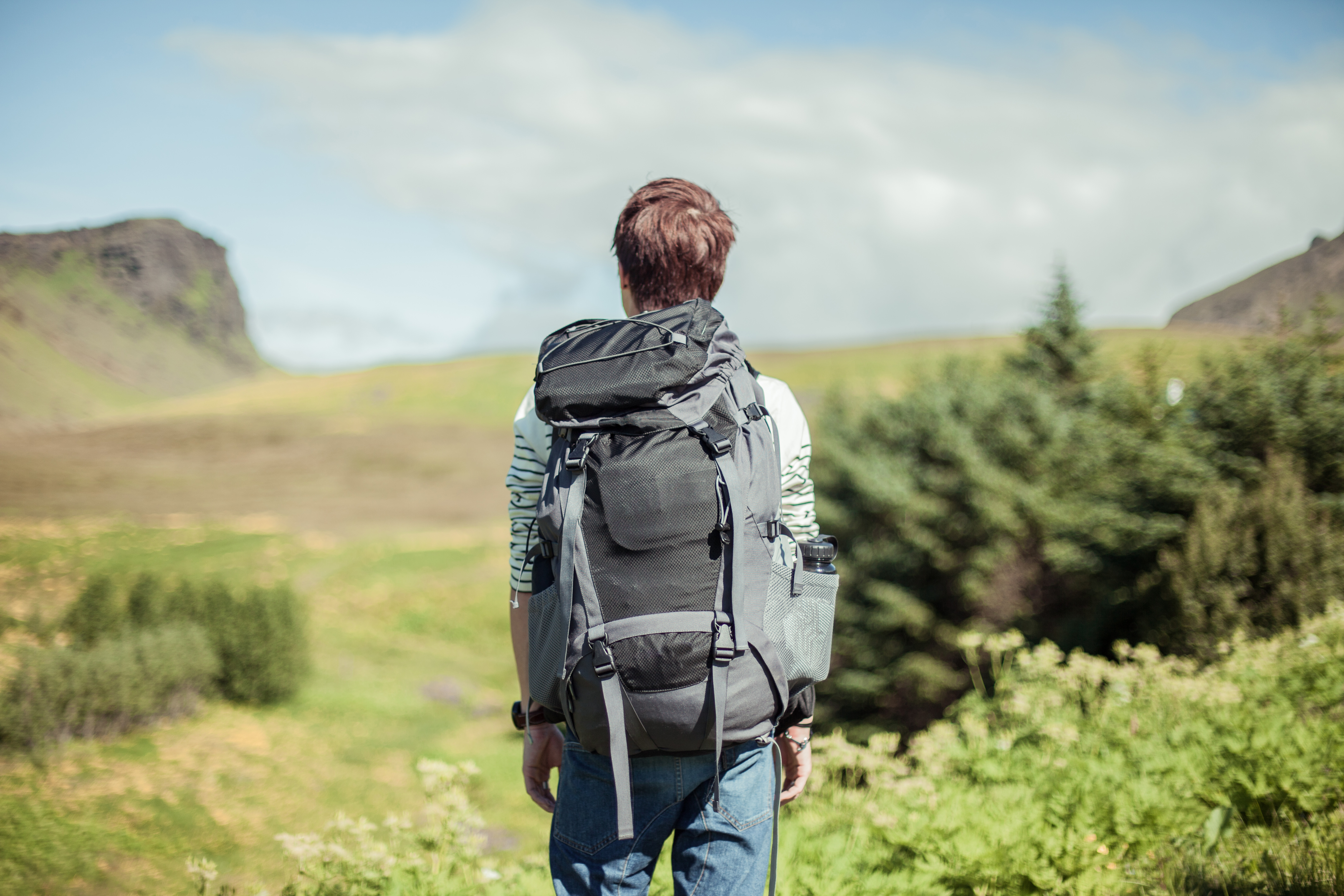 young-man-hiking-rear-view