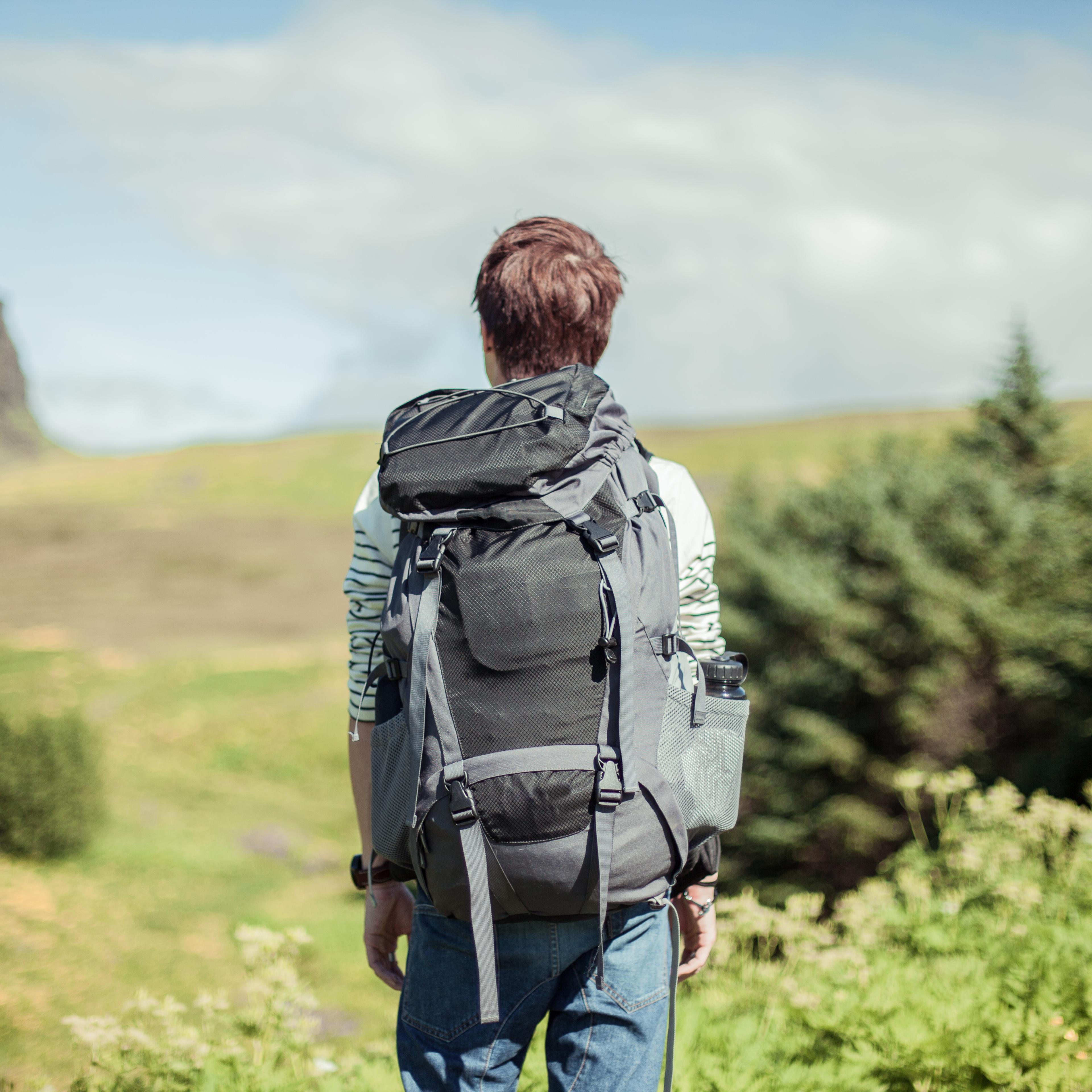 young-man-hiking-rear-view