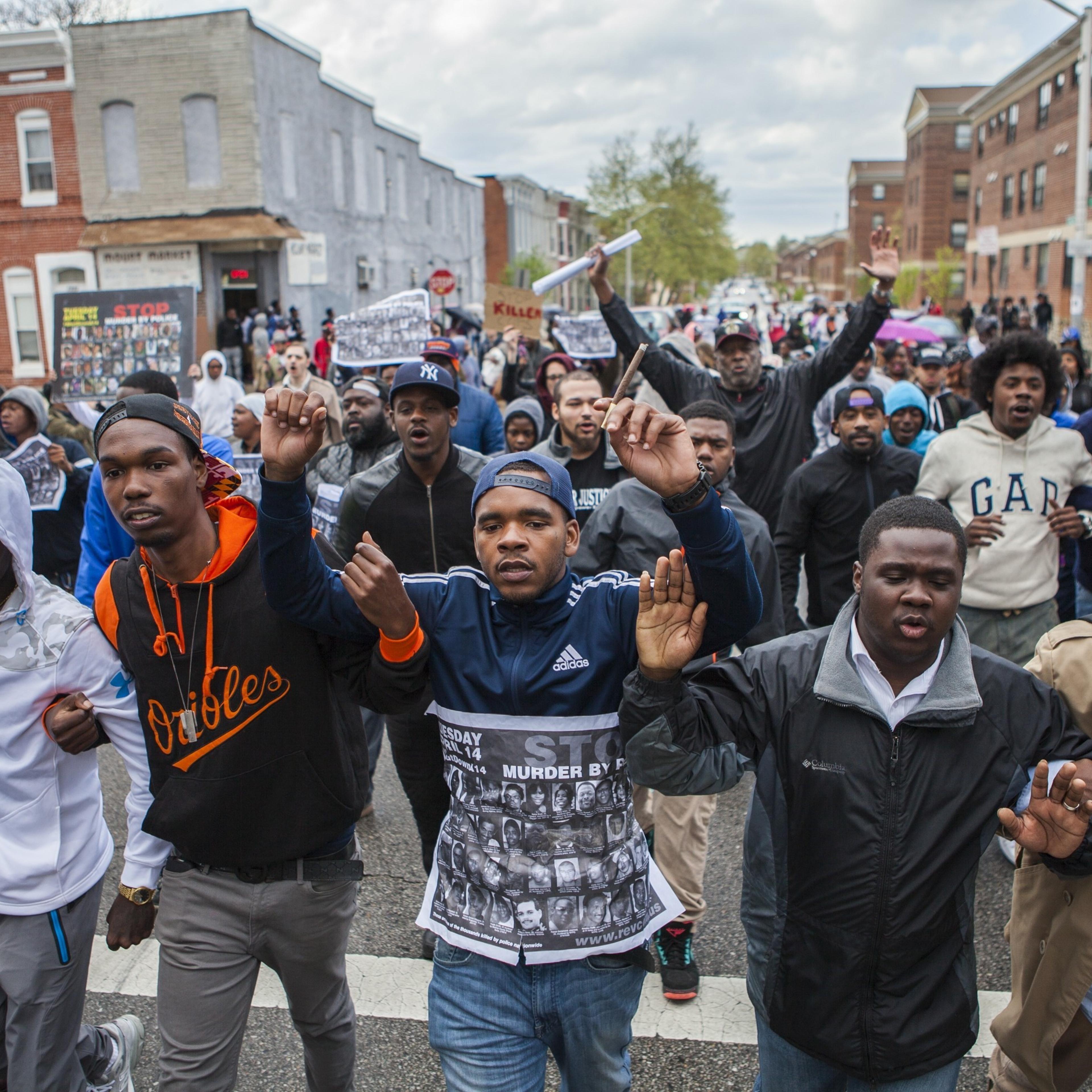 Hundreds of people march through the streets of Baltimore to seek justice for the death for Freddie Gray who died from injuries suffered in Police custody, Baltimore on April 22, 2015.