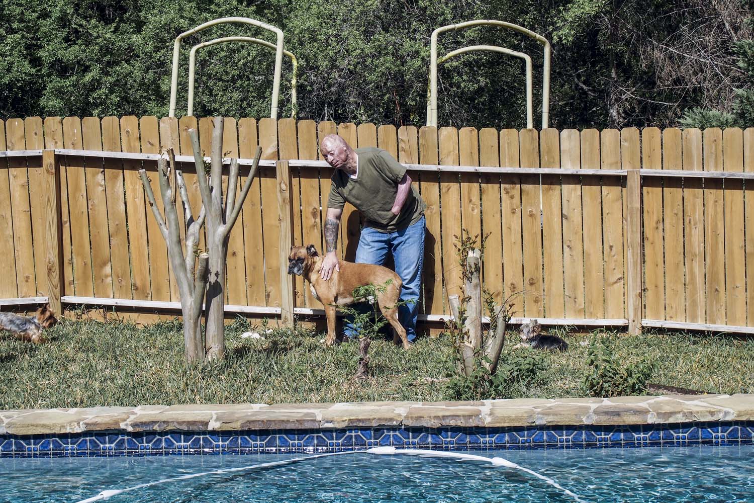 2013.  San Antonio, TX.  USA.  Bobby at home in San Antonio with his dog.  Bobby Henline, 41, veteran of four tours to Iraq and sole survivor of an IED blast that killed the other four soldiers in his humvee in Iraq in 2007.  He is now a standup comedian