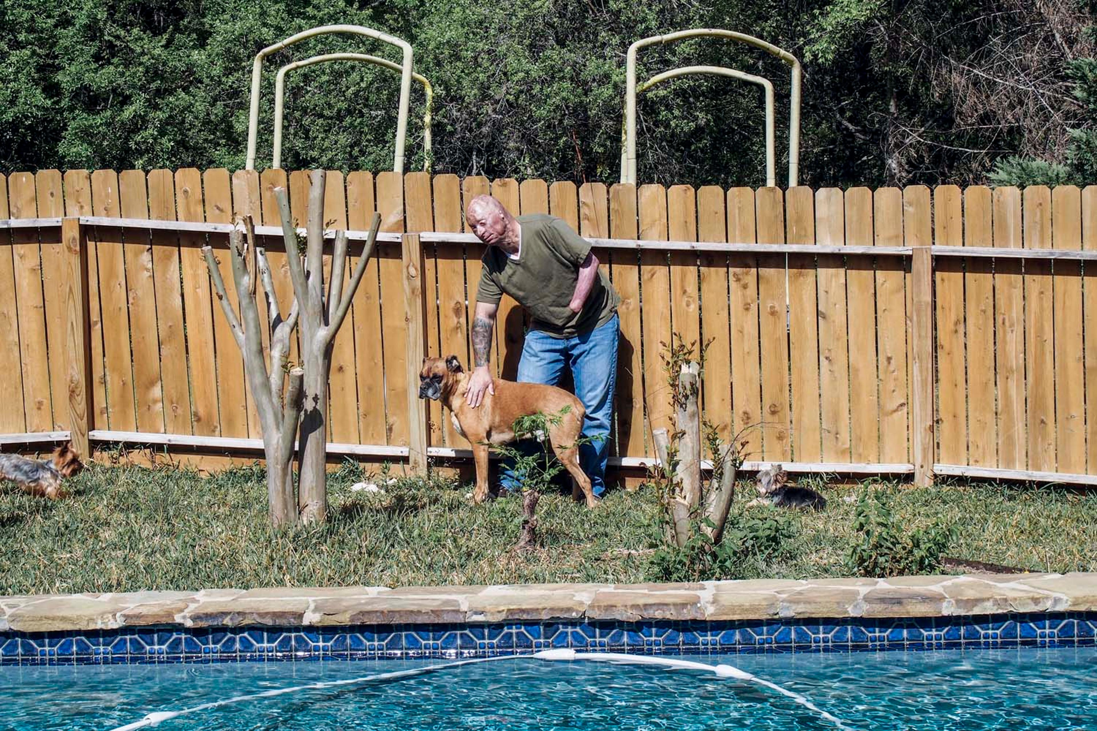 2013. San Antonio, TX. USA. Bobby at home in San Antonio with his dog. Bobby Henline, 41, veteran of four tours to Iraq and sole survivor of an IED blast that killed the other four soldiers in his humvee in Iraq in 2007. He is now a standup comedian