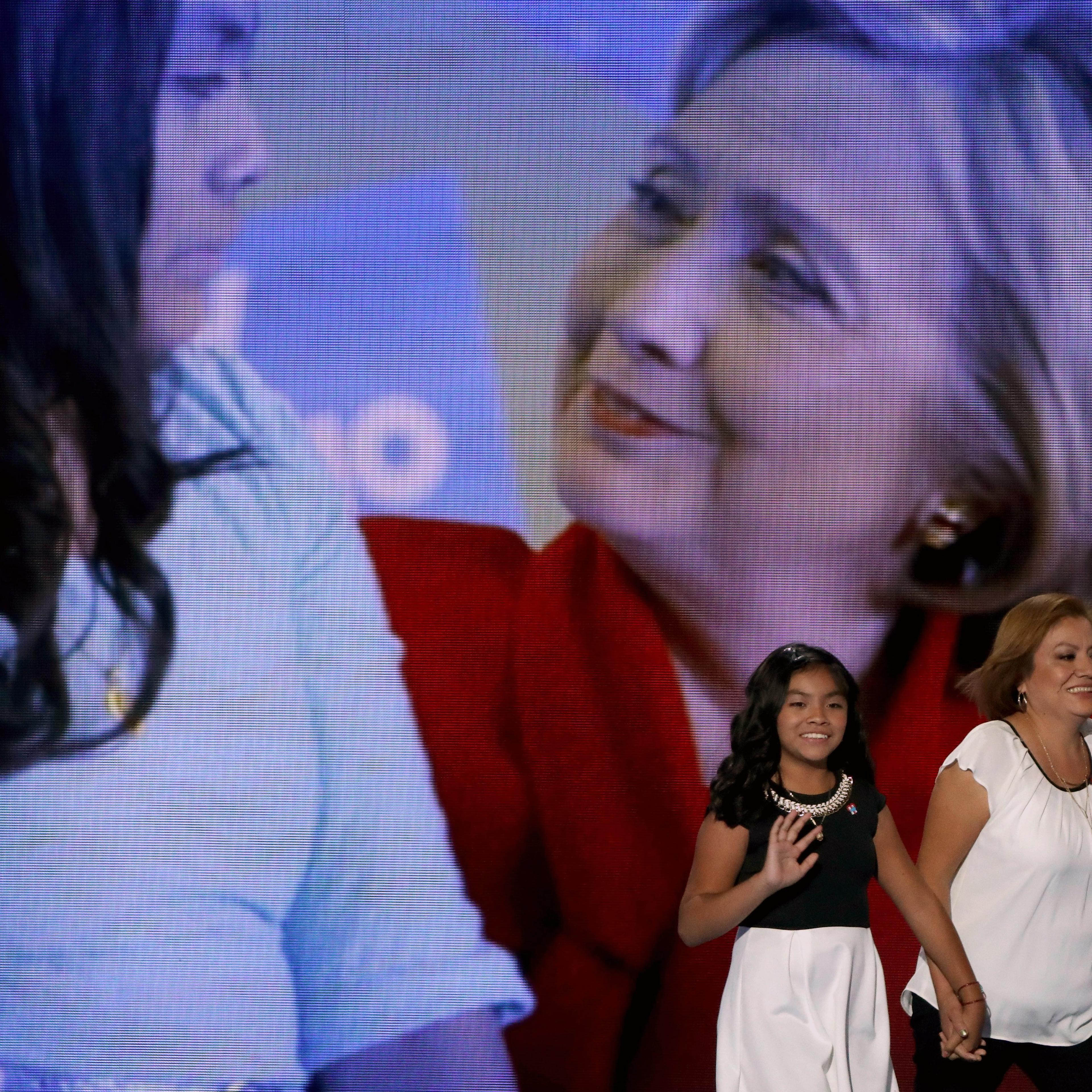 Karla Ortiz, 11, and her mother, Francisca Ortiz, walk out on stage to deliver remarks on the first day of the Democratic National Convention at the Wells Fargo Center, July 25, 2016 in Philadelphia.