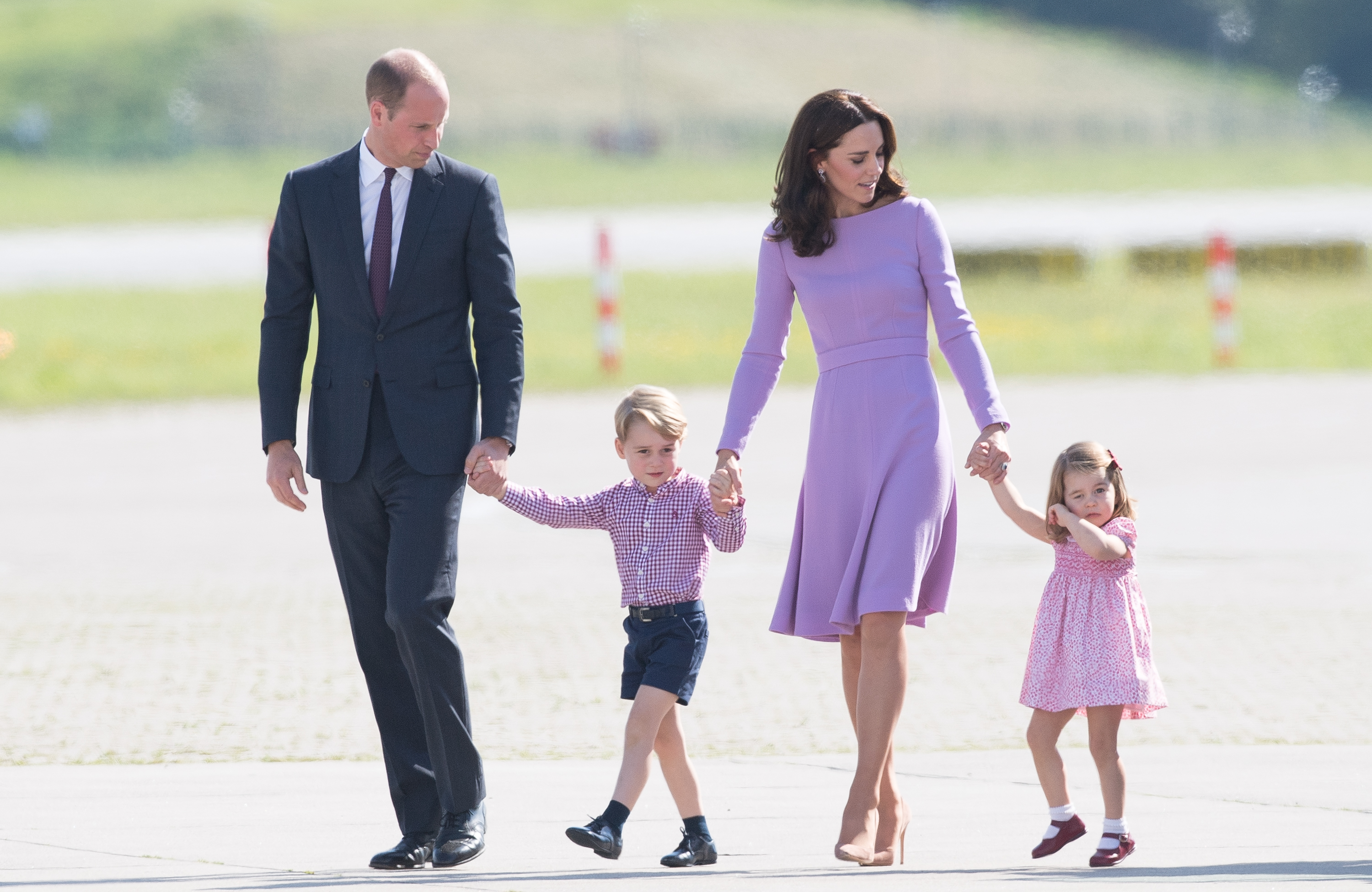 Prince William, Duke of Cambridge, Prince George, Princess Charlotte of Cambridge and Catherine, Duchess of Cambridge view helicopter models H145 and H135 before departing from Hamburg airport on the last day of their official visit to Poland and Germany