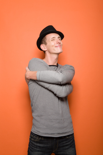 man-hugging-self-smiling