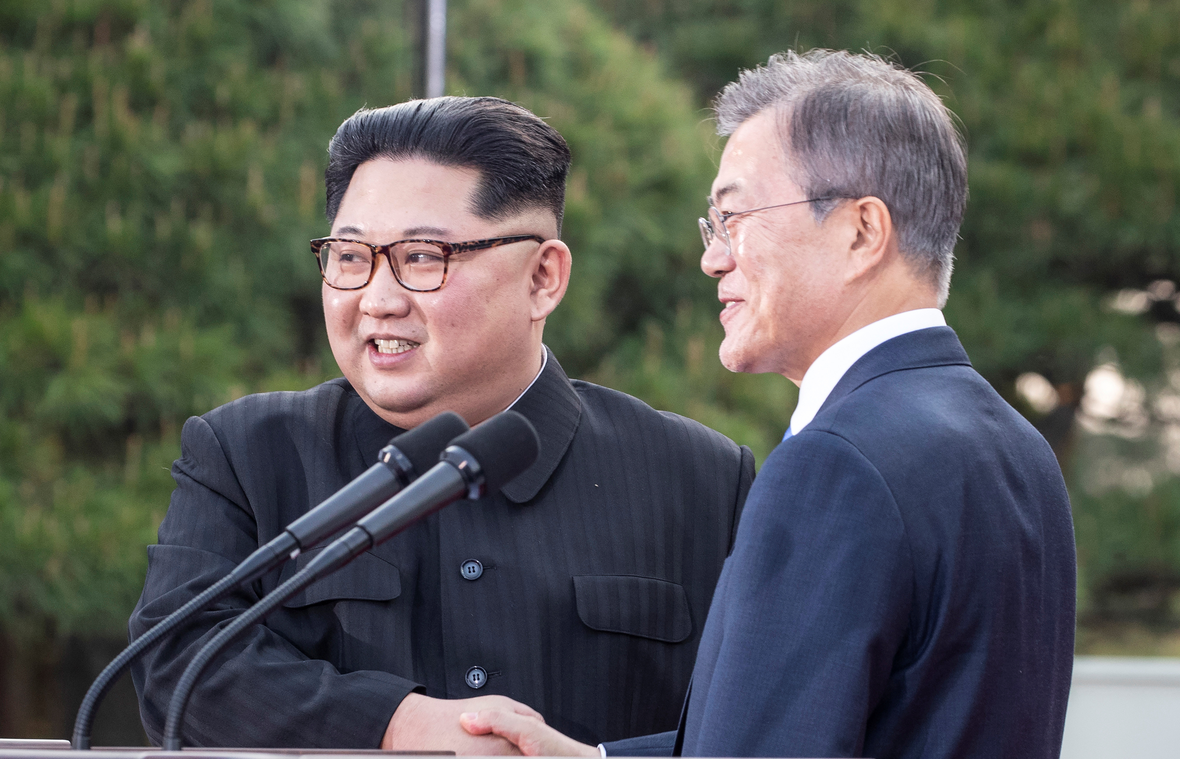 South Korean President Moon Jae-in and North Korean leader Kim Jong Un shake hands at the truce village of Panmunjom