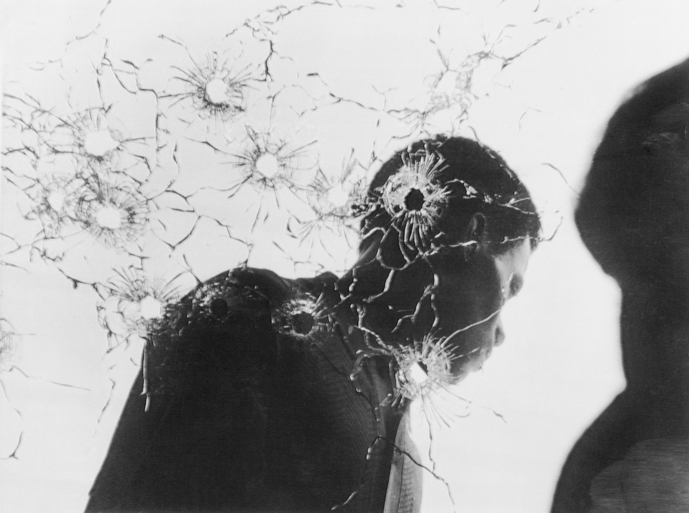 Man Behind Bullet-Riddled Glass