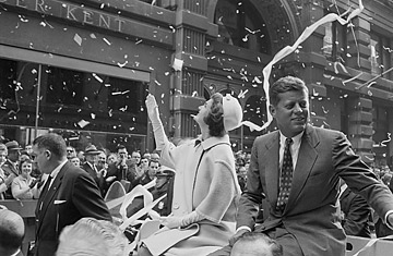 Presidential candidate John F. Kennedy rides on a car with wife Jackie in a ticker-tape parade, Oct. 19, 1960