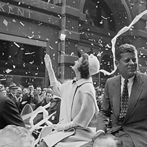 Presidential candidate John F. Kennedy rides on a car with wife Jackie in a ticker-tape parade, Oct. 19, 1960
