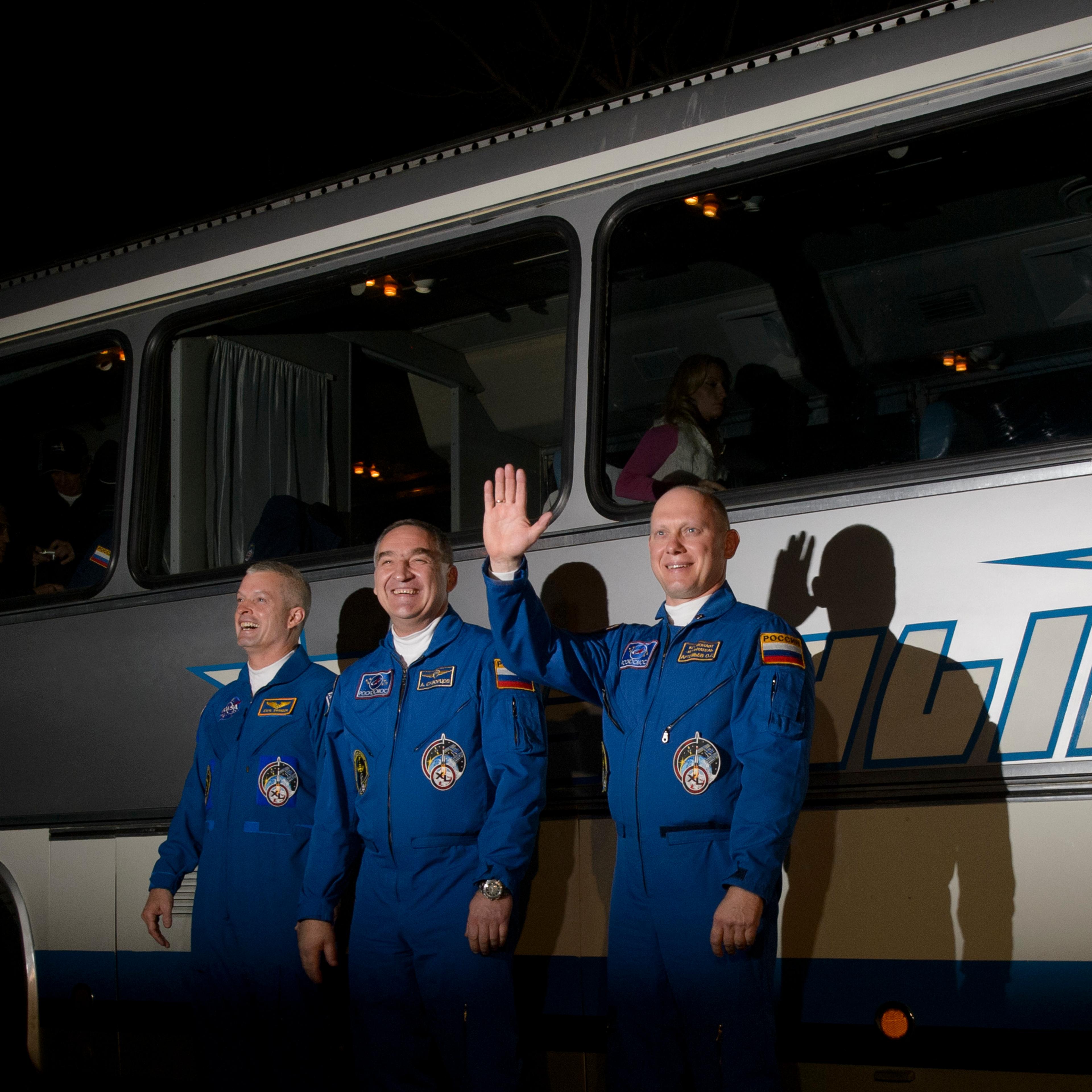 American astronaut Steve Swanson, left, and cosmonauts Alexander Skvortsov and Oleg Artemyev, are seen as they depart the Cosmonaut Hotel, Tuesday, March 25, 2014, in Baikonur, Kazakhstan, prior to their launch aboard a Soyuz rocket