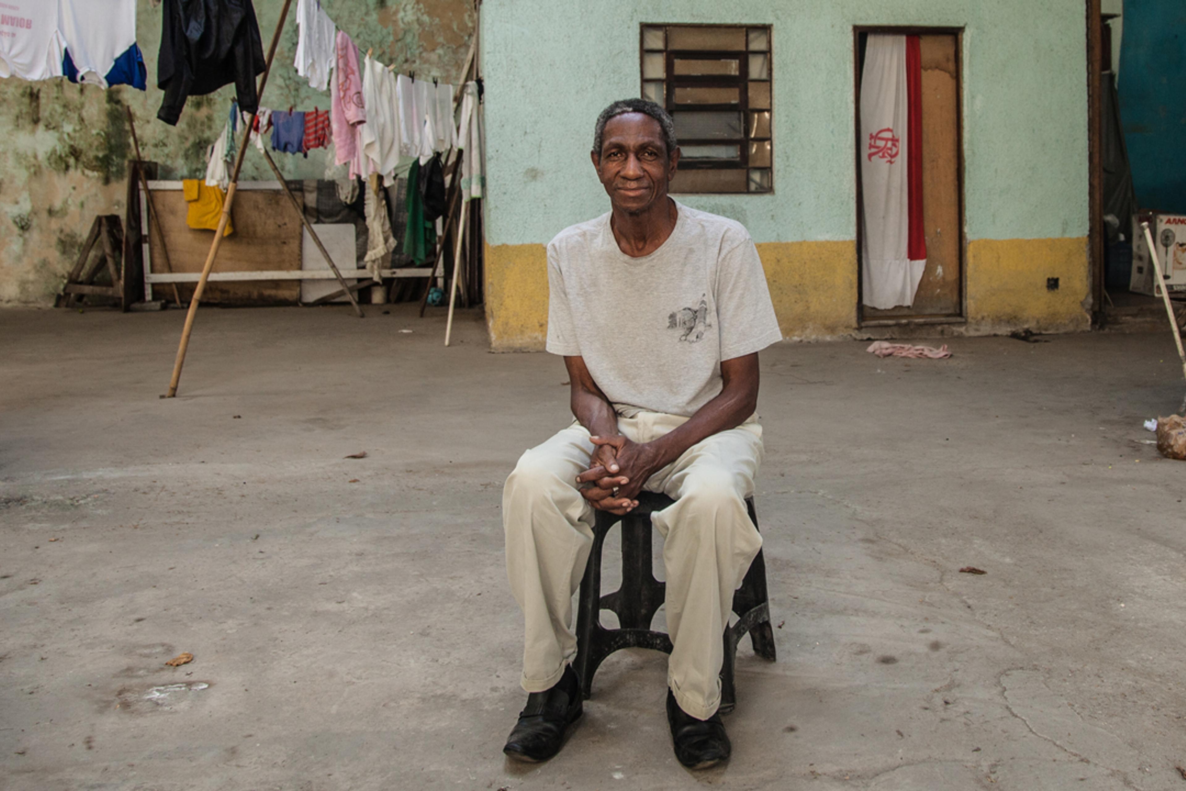 Paulo Cezar de Paula, 62, sitting in the abandoned warehouse he has been squatting for three years in the port area of Rio de Janeiro, on July 25, 2016.