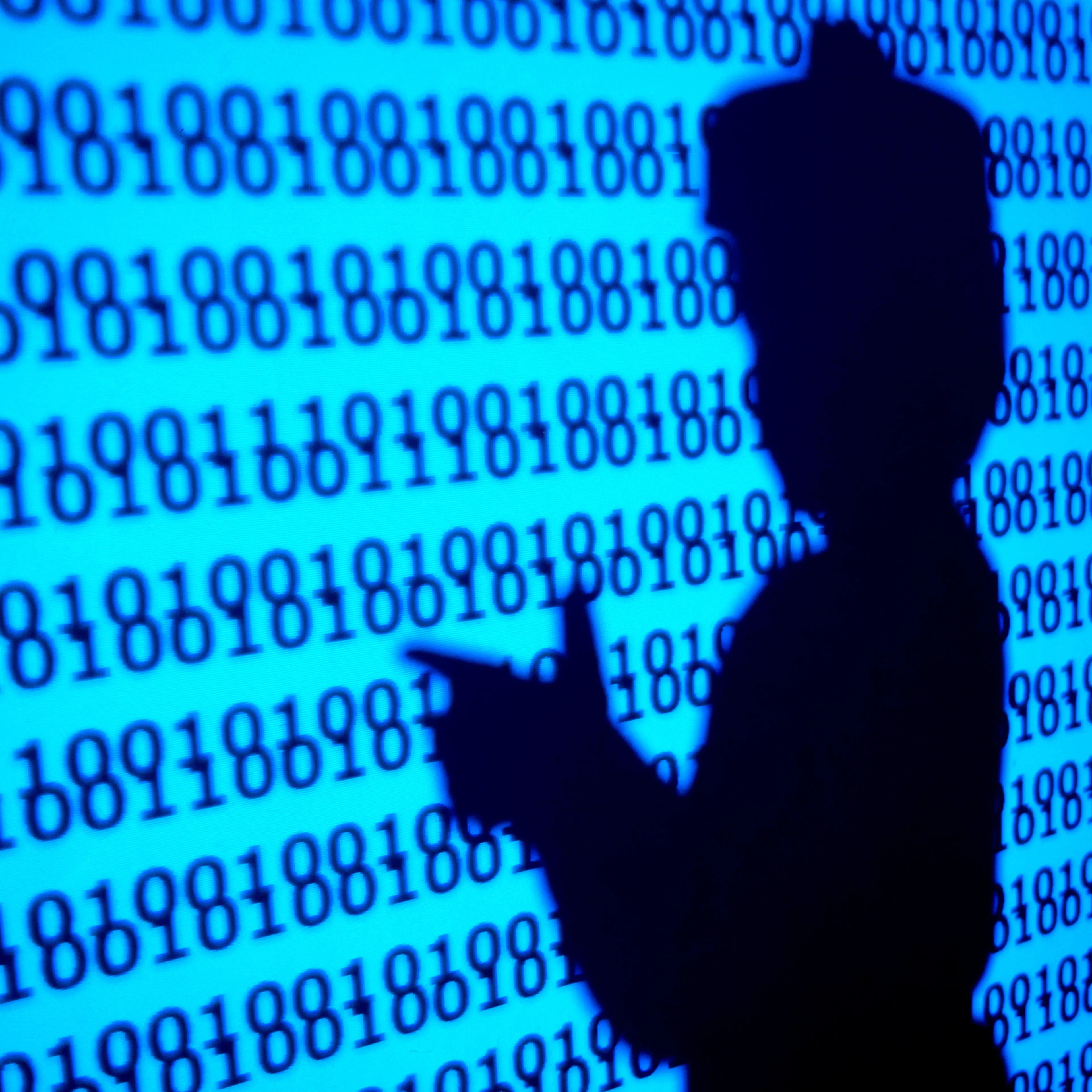Silhouette of a person (child) playing in a virtual world of programs, making the gesture of shooting with his hands.