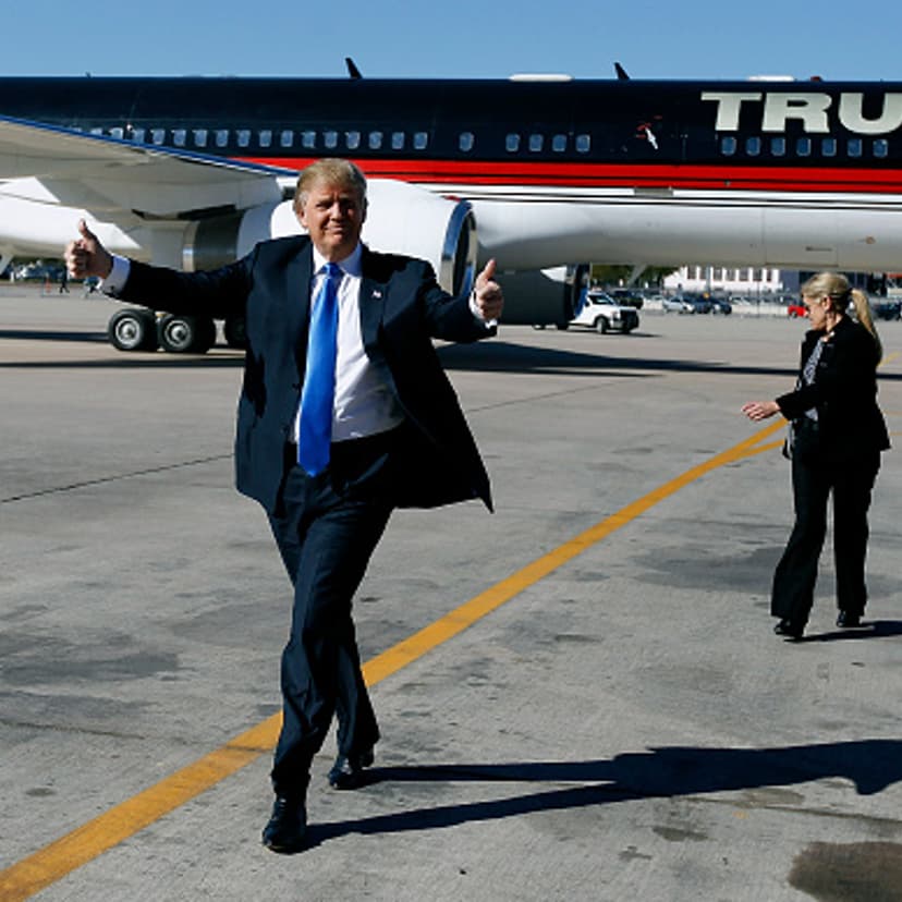 Republican presidential candidate Donald Trump gives a thumbs up to the crowd as he arrives at a campaign event at the International Air Response facility on December 16, 2015 in Mesa, Arizona.