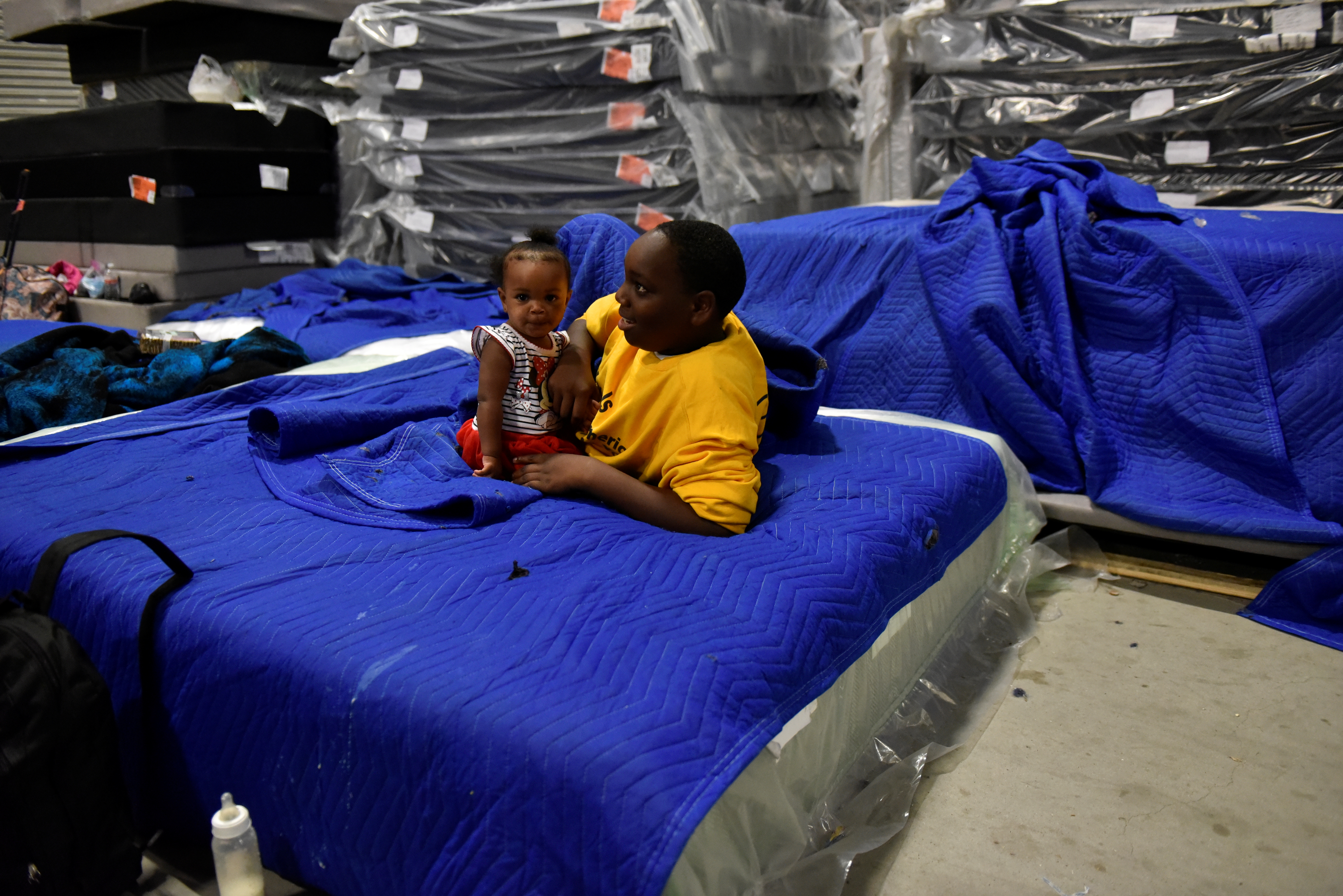 Harvey evacuees seen in the warehouse at Gallery Furniture in Houston