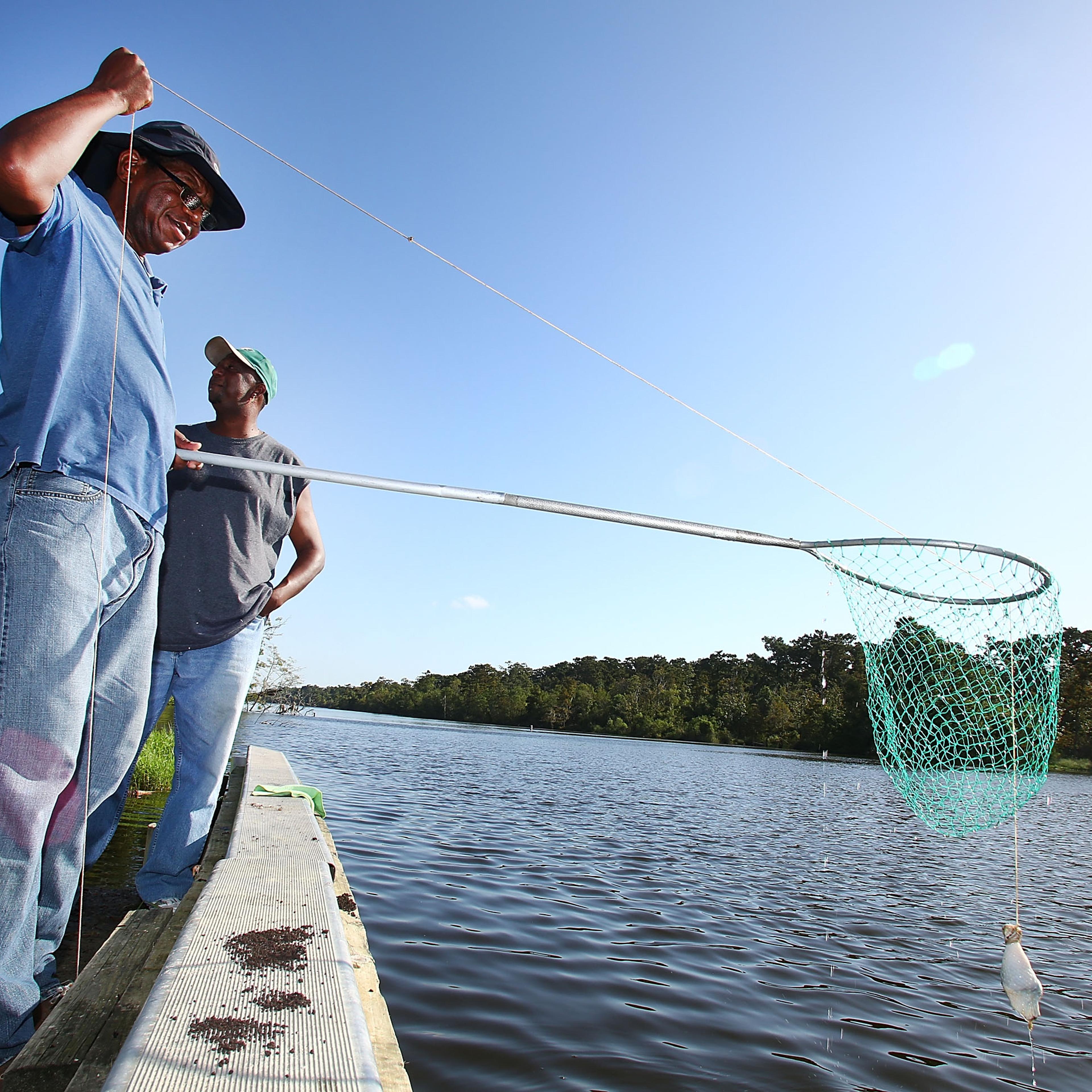 Mike Coleman and Jarad Williams check their crab traps on October 4, 2013 in Grand Isle, Louisiana.