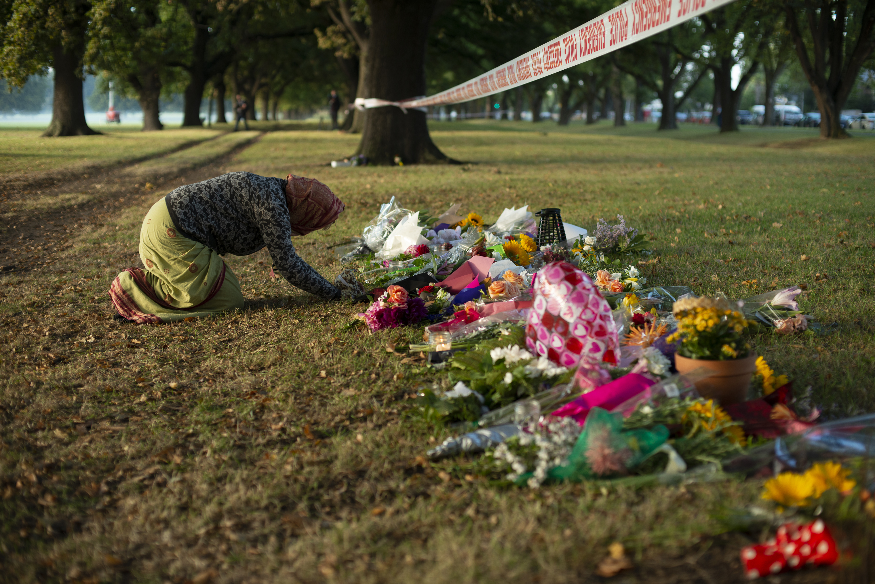 Early morning prayers at Masjid Al Noor Mosque memorial site in Hagley Park, where one of the two mass shootings occurred, Christchurch, New Zealand, March 17, 2019.