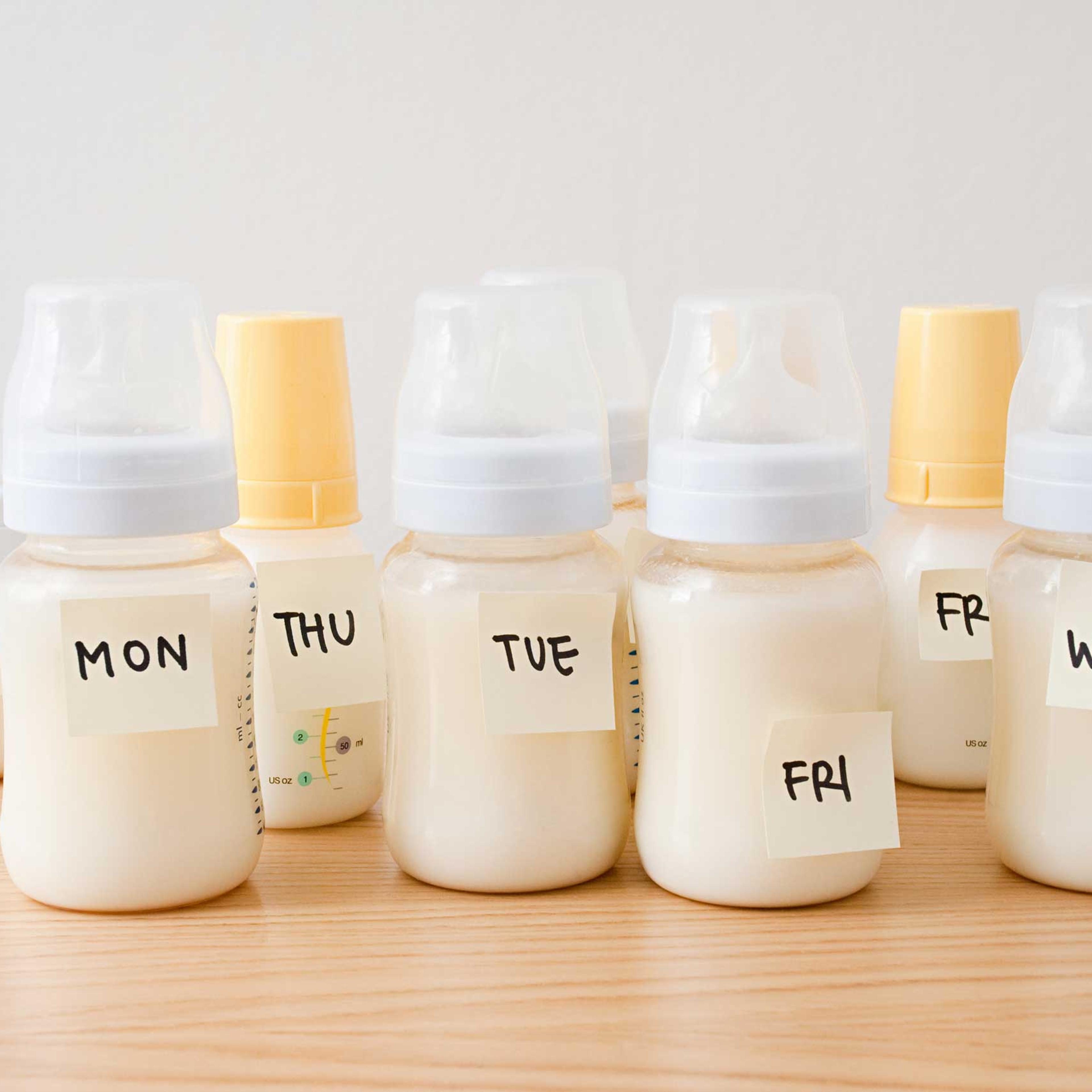 Baby bottles with days of the week on adhesive notes